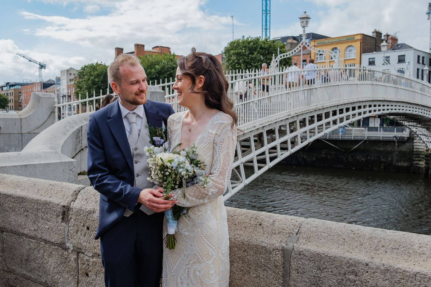 Newlyweds share intimate moments on historic Ha'penny Bridge in Dublin.