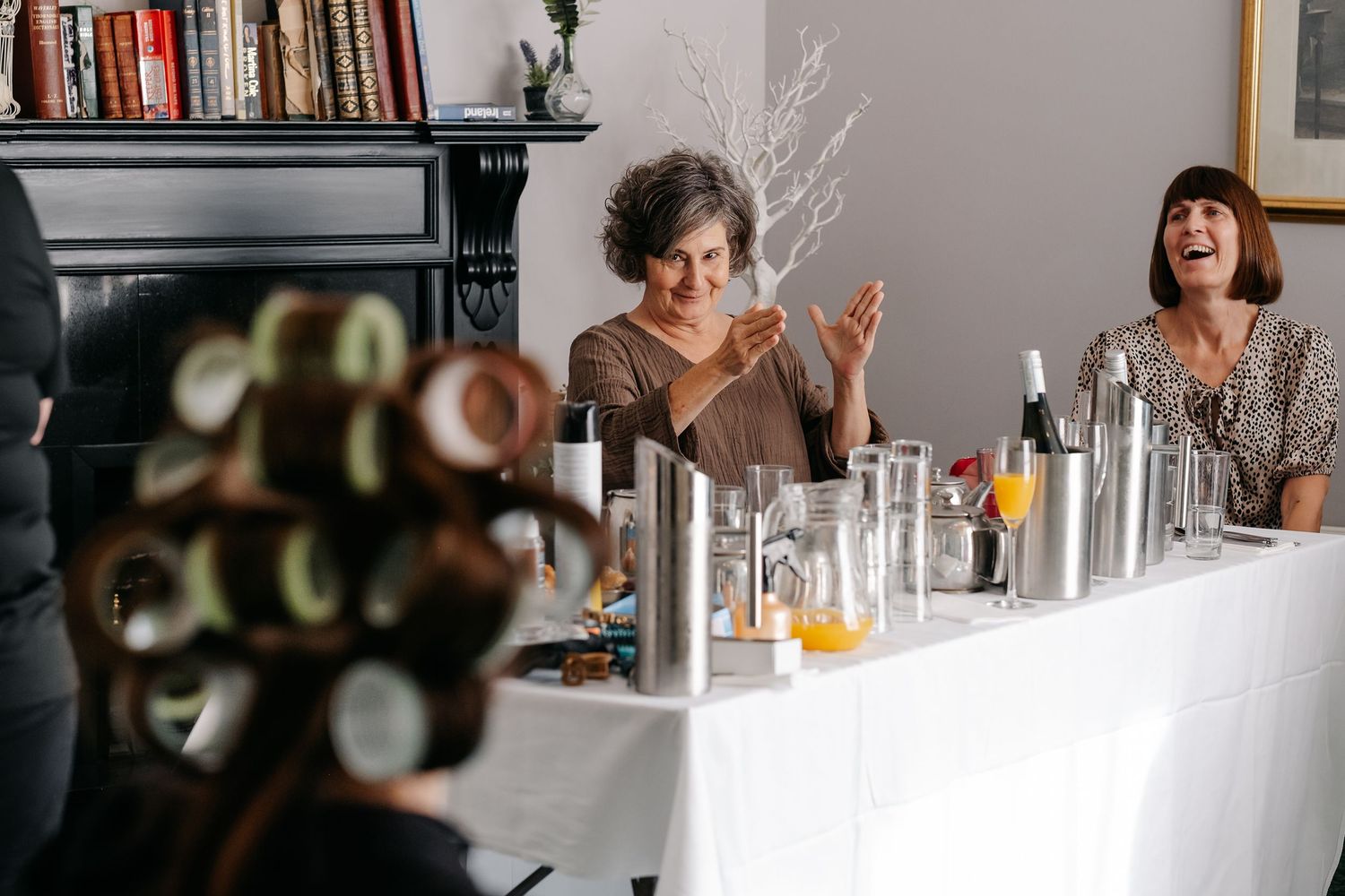 Reception venue features modern decor with bookshelves and minimalist table settings.