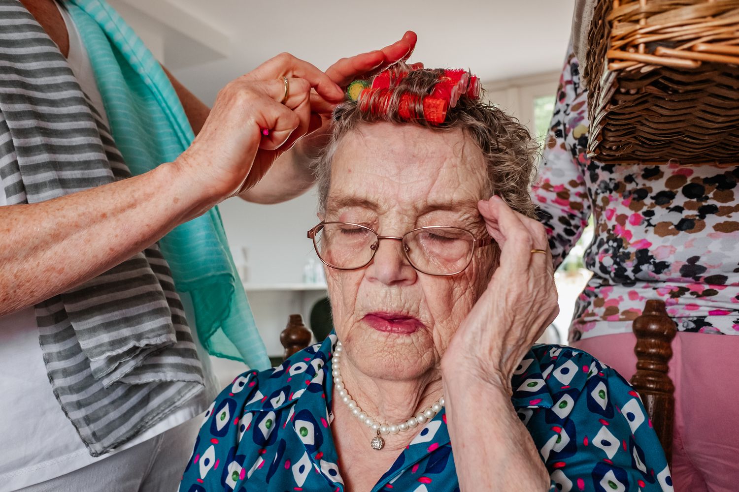 Someone getting their hair styled with curlers.