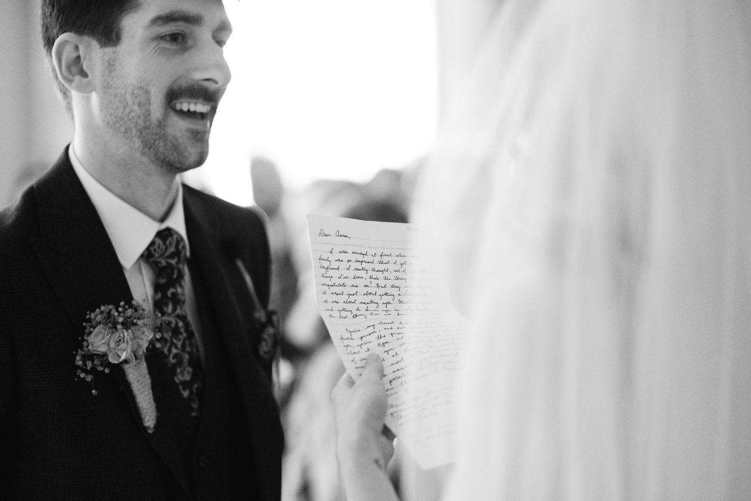 Black and white candid wedding moments showing natural reactions and emotions during speeches.