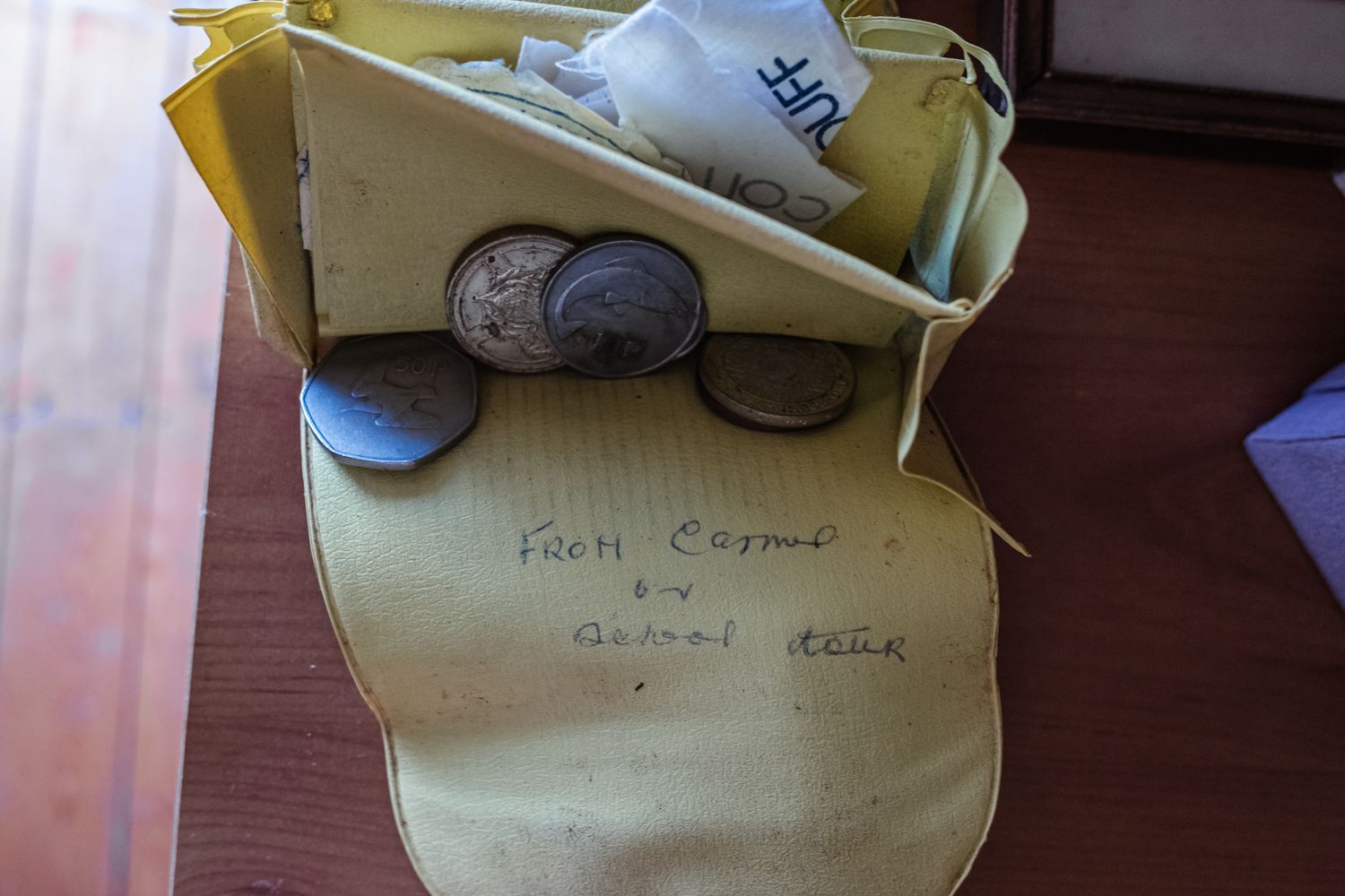 Old glasses and papers rest on a yellow folder.