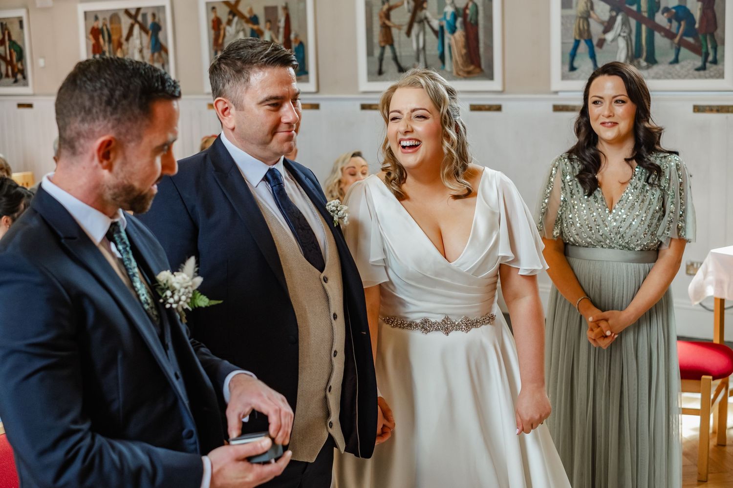 A joyful moment captured during a wedding ceremony with the wedding party in formal attire.