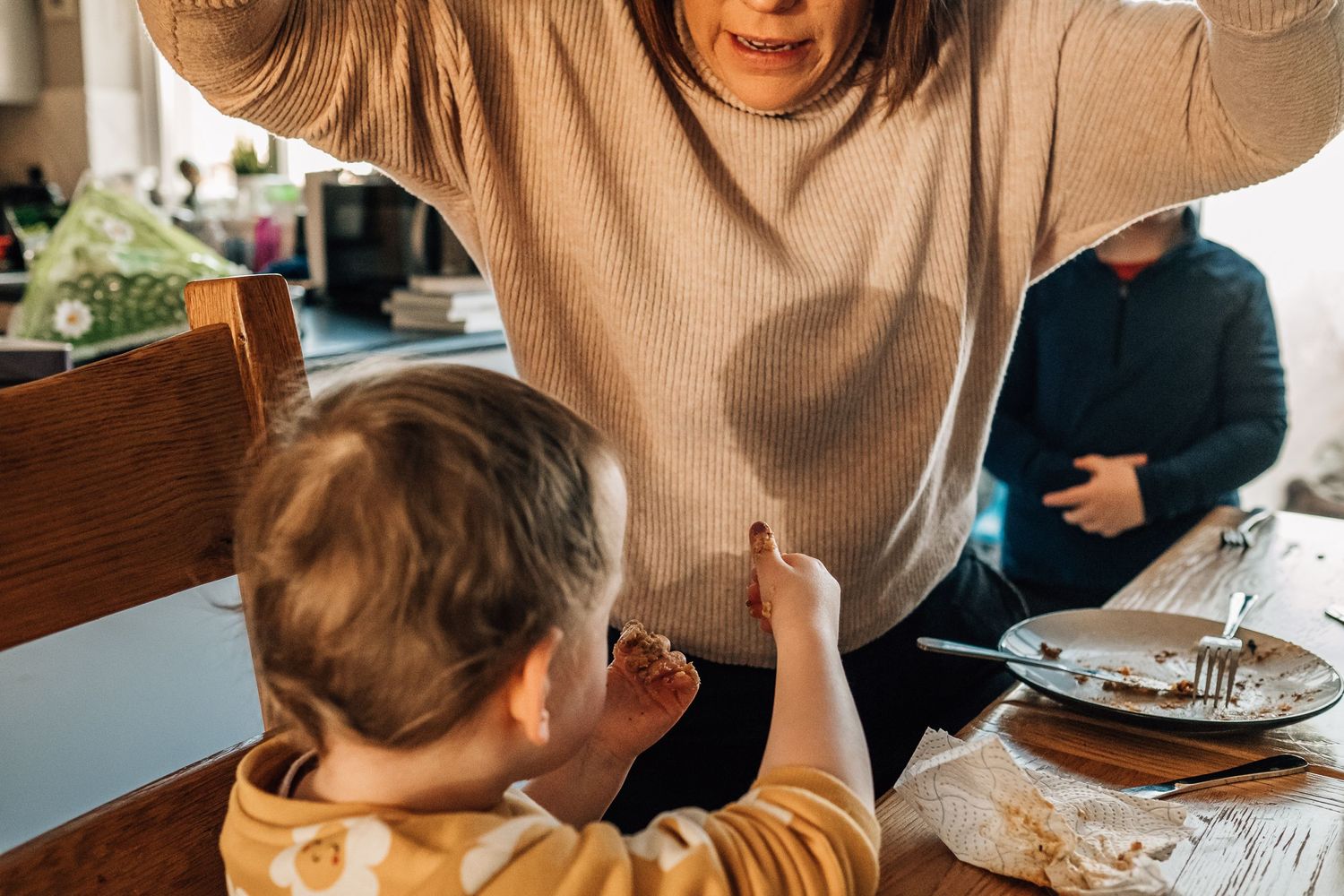 Family interaction during mealtime at dining table.