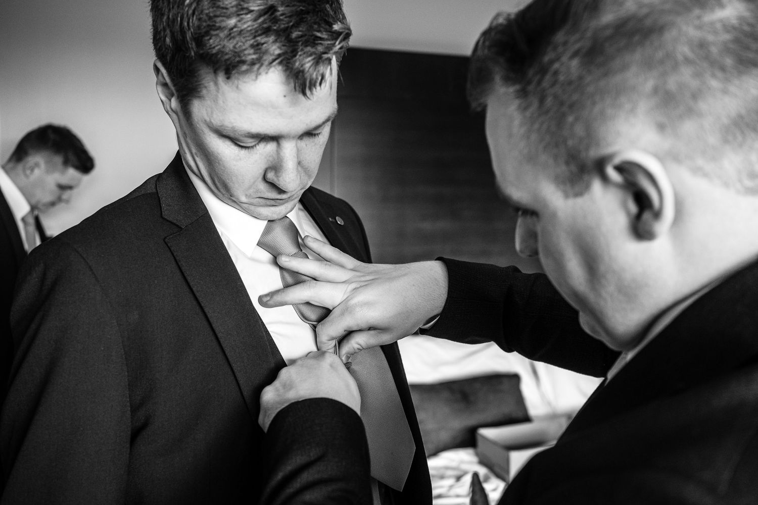 A candid black and white photo of business colleagues having a discussion around a table.