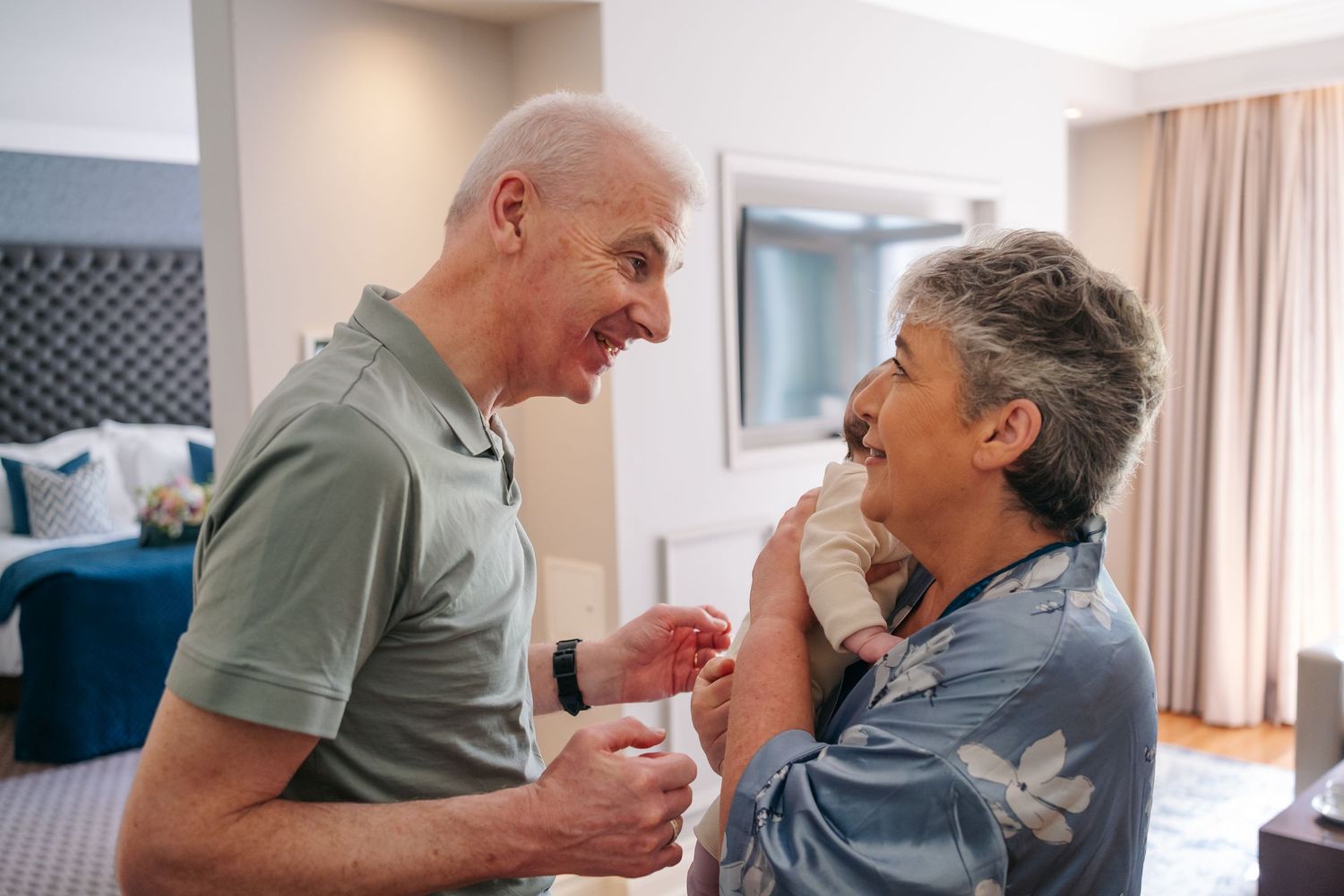 A happy senior couple sharing a tender moment while sitting together indoors.