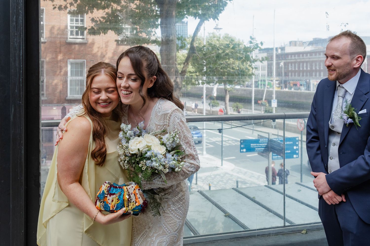 Joyful celebration moment at a wedding with city view in background.