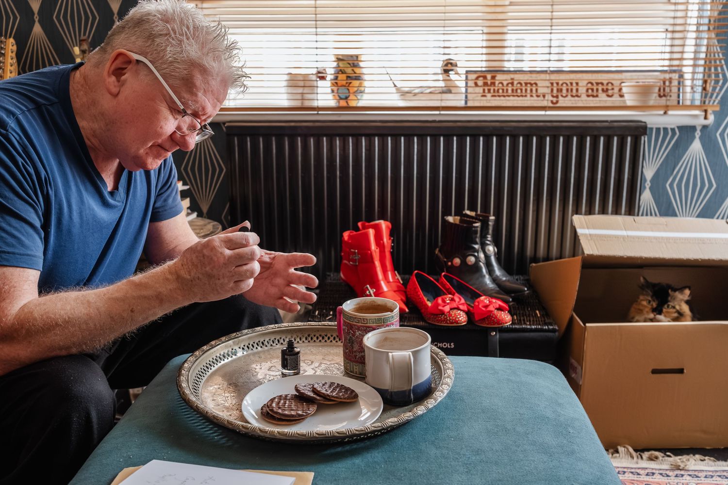 Person examining items on serving tray with red decorative elements in background.