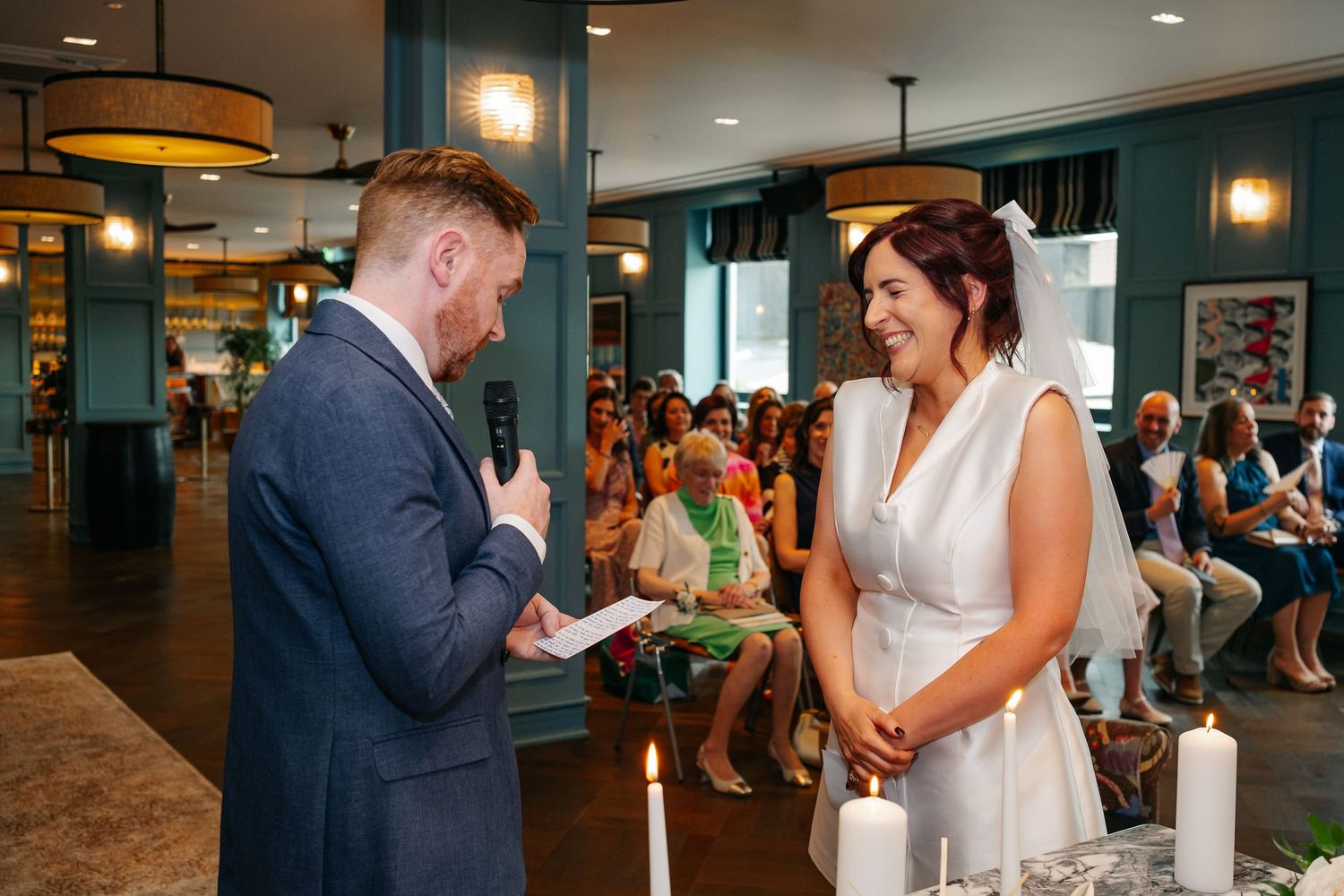 Wedding reception venue with modern decor and warm lighting during celebration.