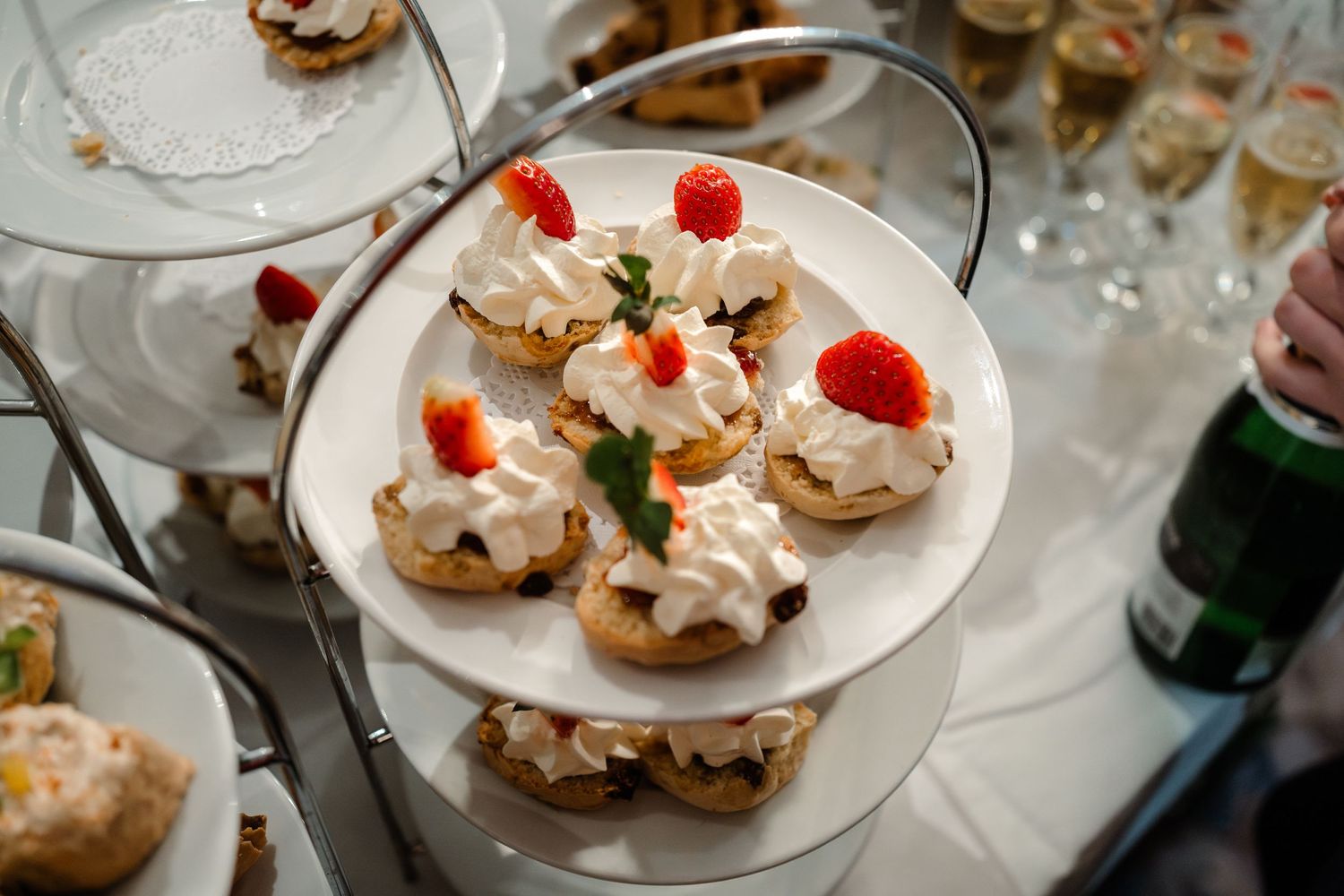 Dessert plate featuring cream puffs decorated with fresh strawberries and mint leaves.