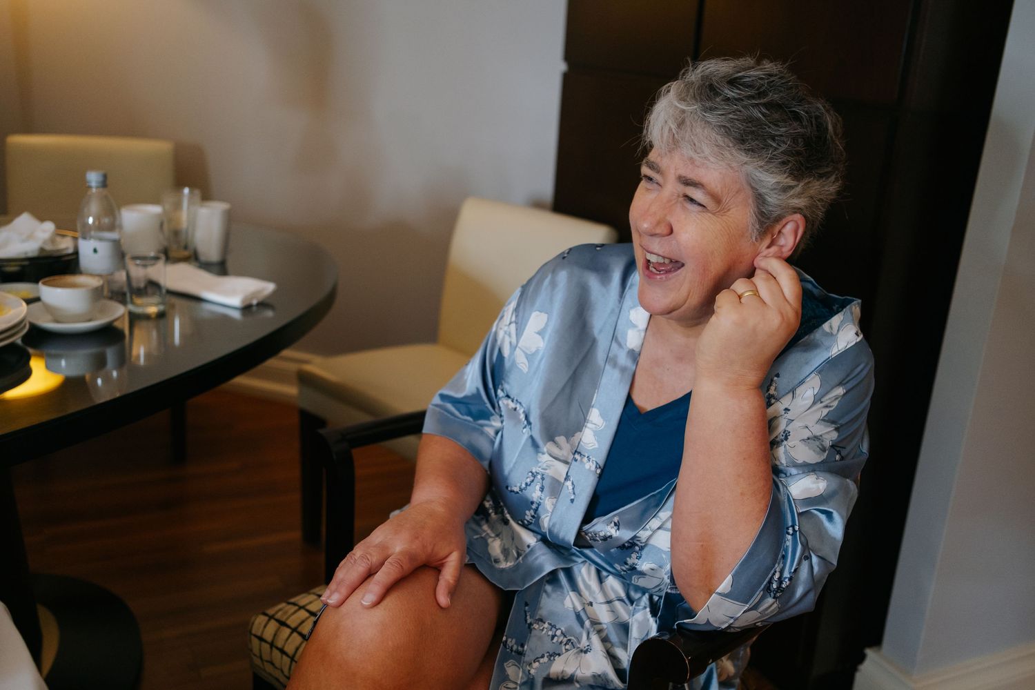 A laughing couple sharing a joyful moment together in a casual dining setting.