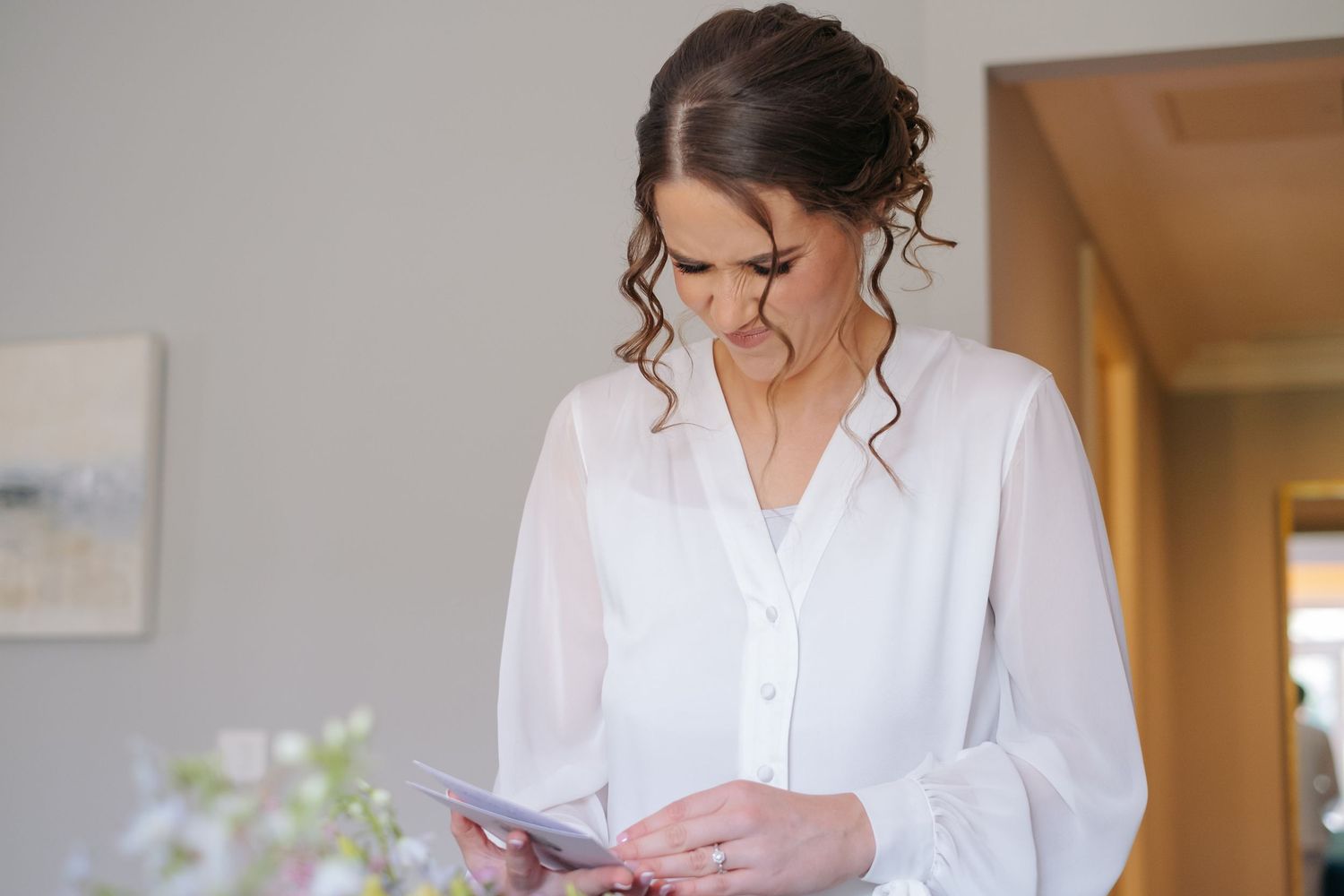Morning preparation scene with white robes in natural window light.