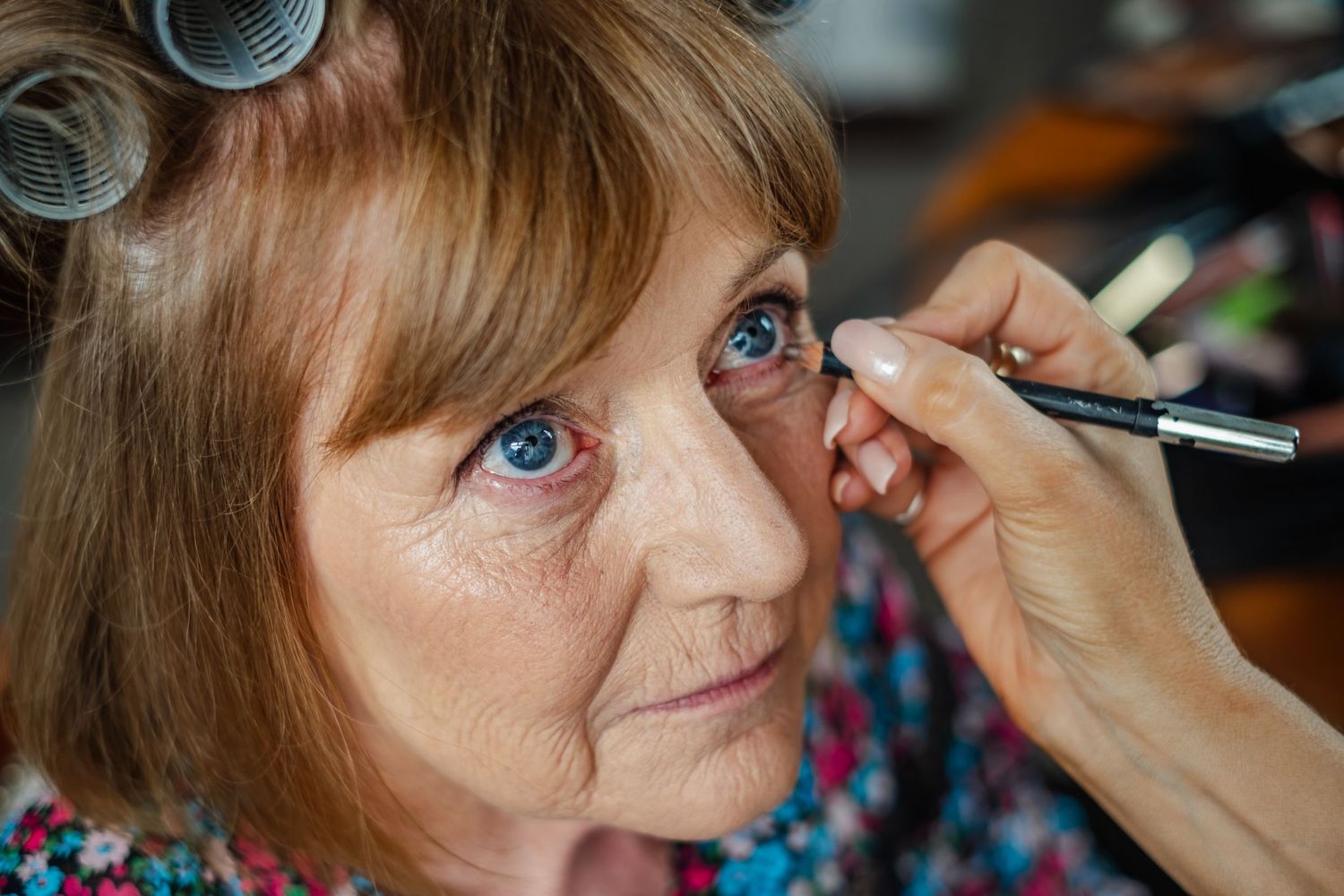 A close-up shot of eye makeup being applied with a fine brush.