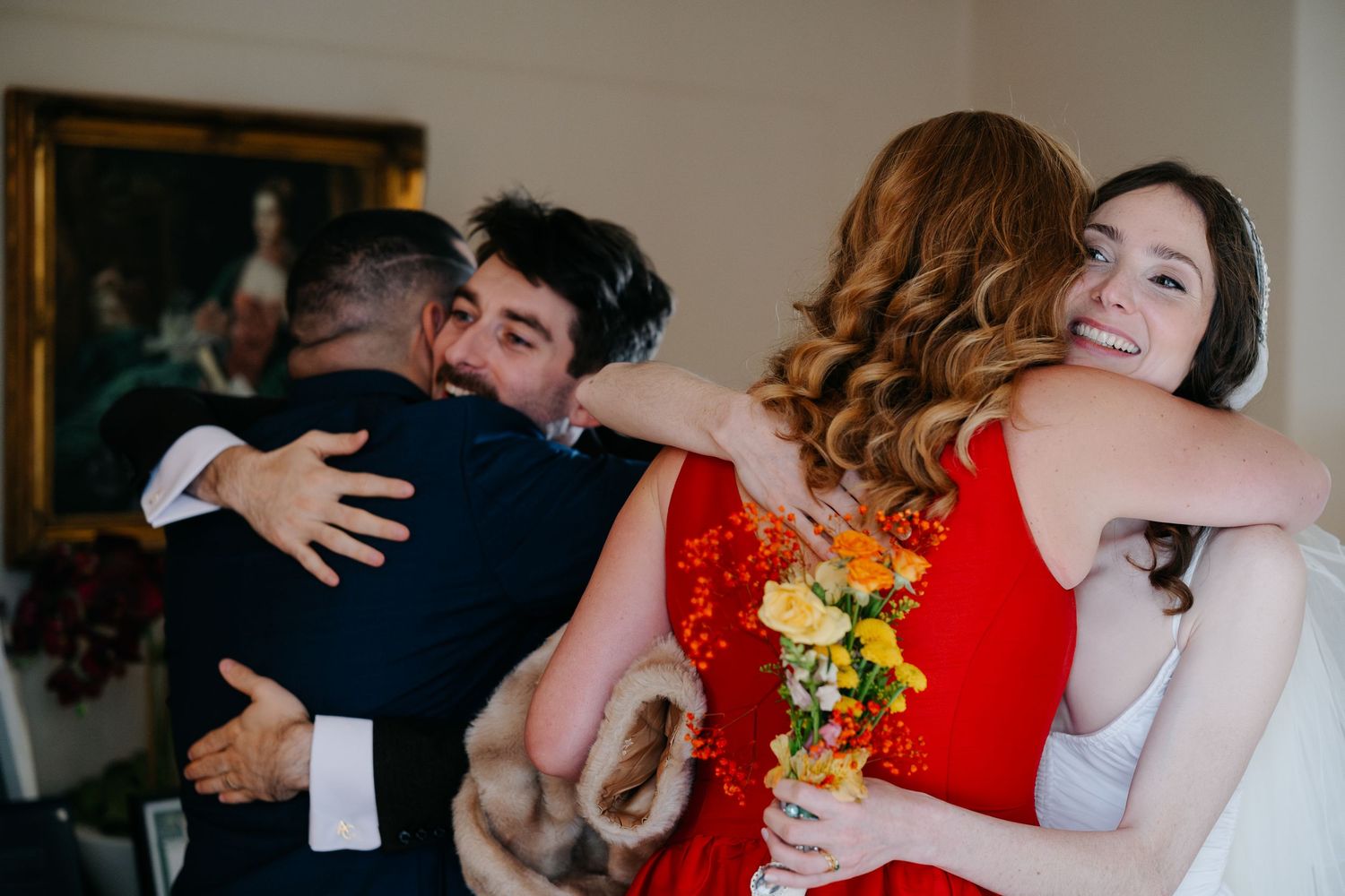A series of candid dance floor moments at a wedding reception with couples in formal attire and red dresses.