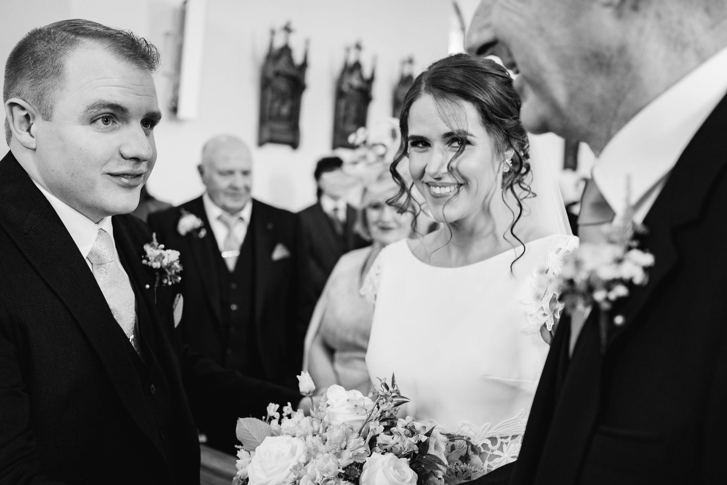 A series of black and white wedding photographs showing happy couples and guests celebrating at a formal reception.