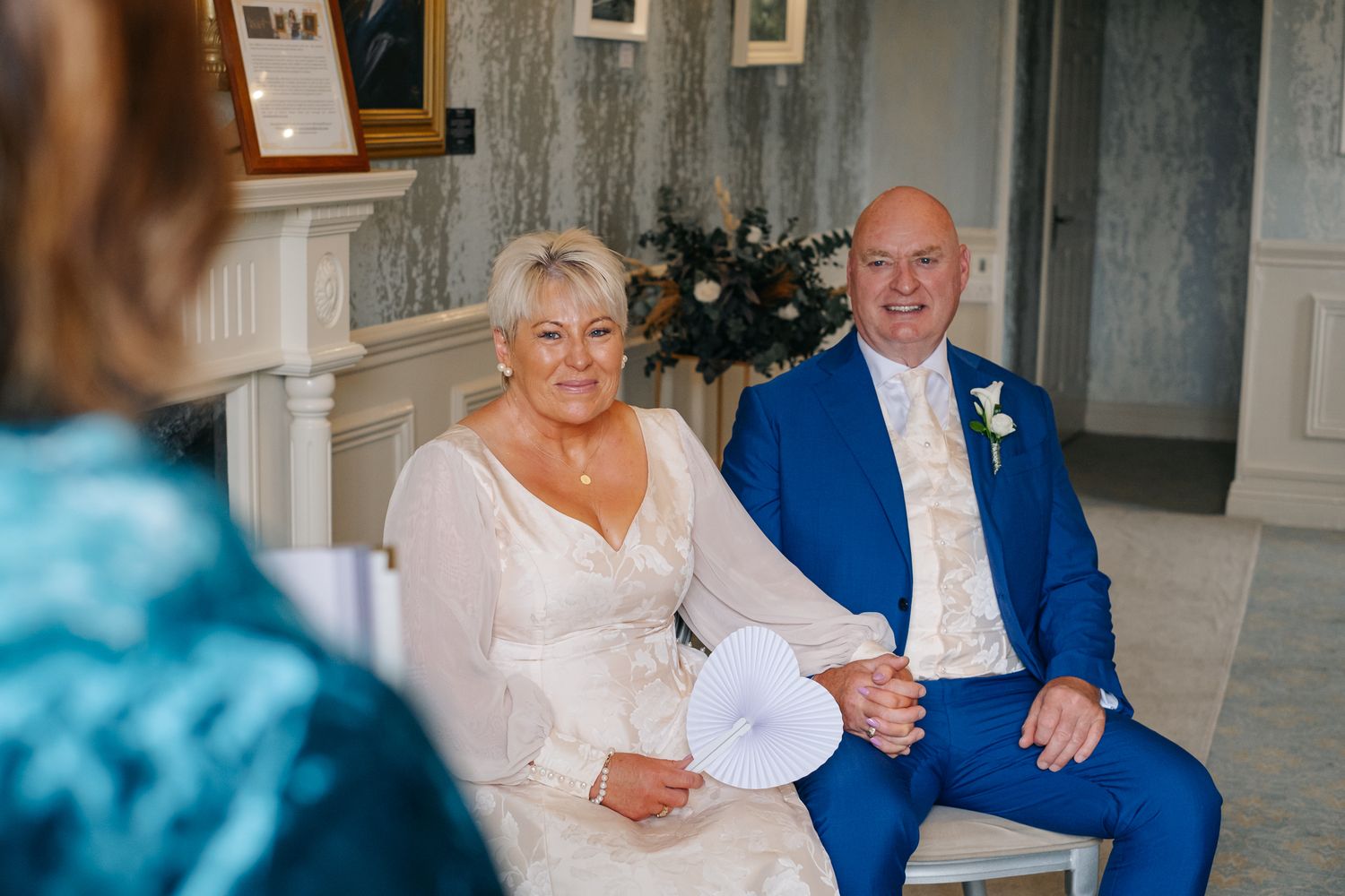 Couple shares intimate moment during wedding celebration in formal attire.