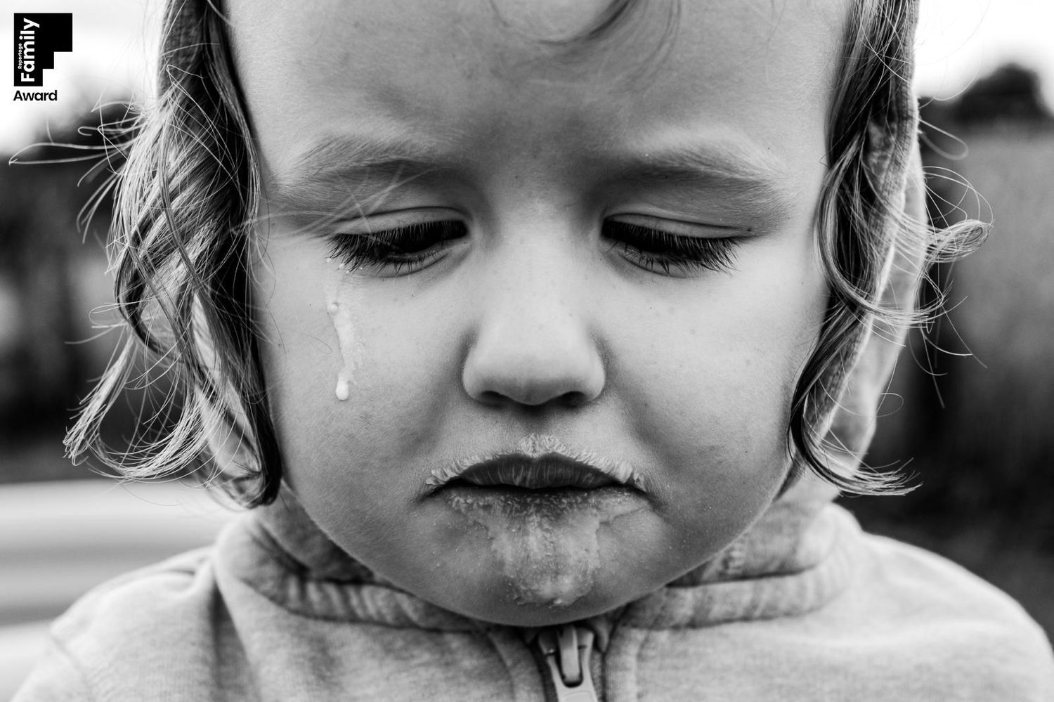 A series of black and white close-up photos showing a child's expressions while eating or tasting food.