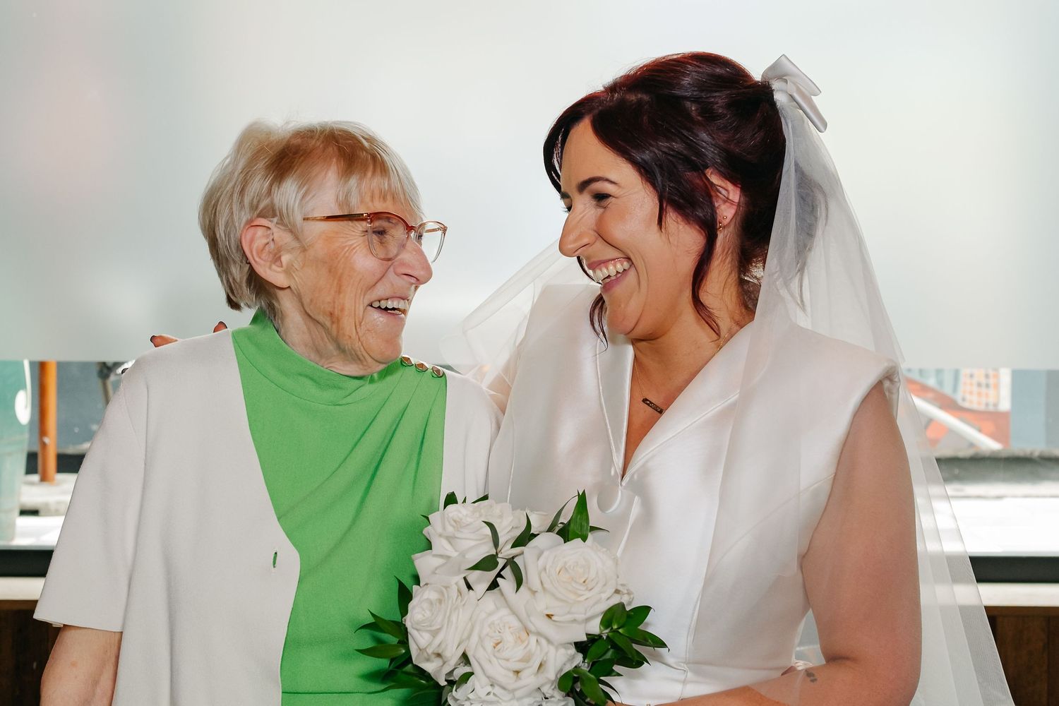 Joyful wedding celebration with bride in white dress sharing tender moments with loved ones.