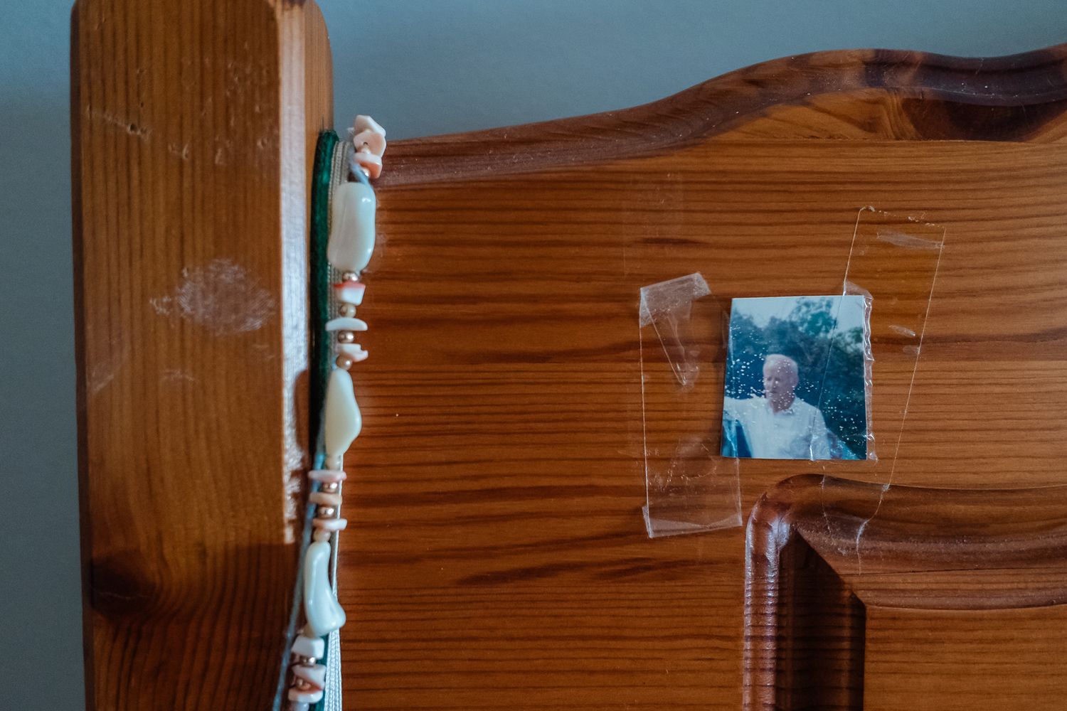 Vintage photograph displayed on wooden headboard.
