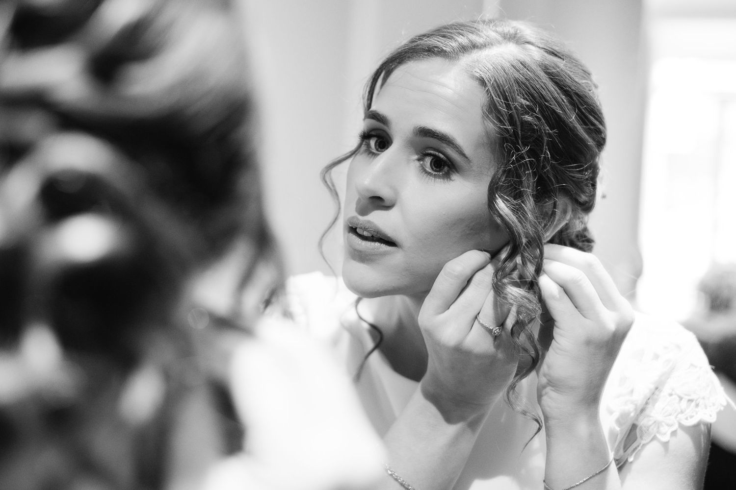 A makeup artist applies eyeshadow during a bridal preparation photoshoot.