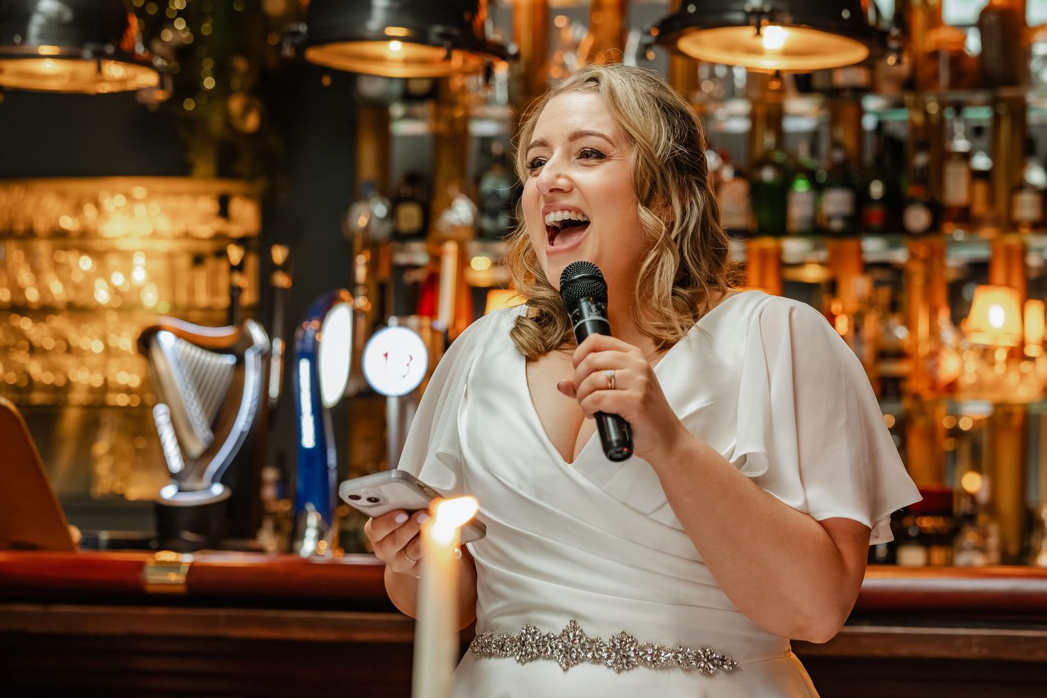 Candlelit bar setting with celebratory atmosphere during evening event.