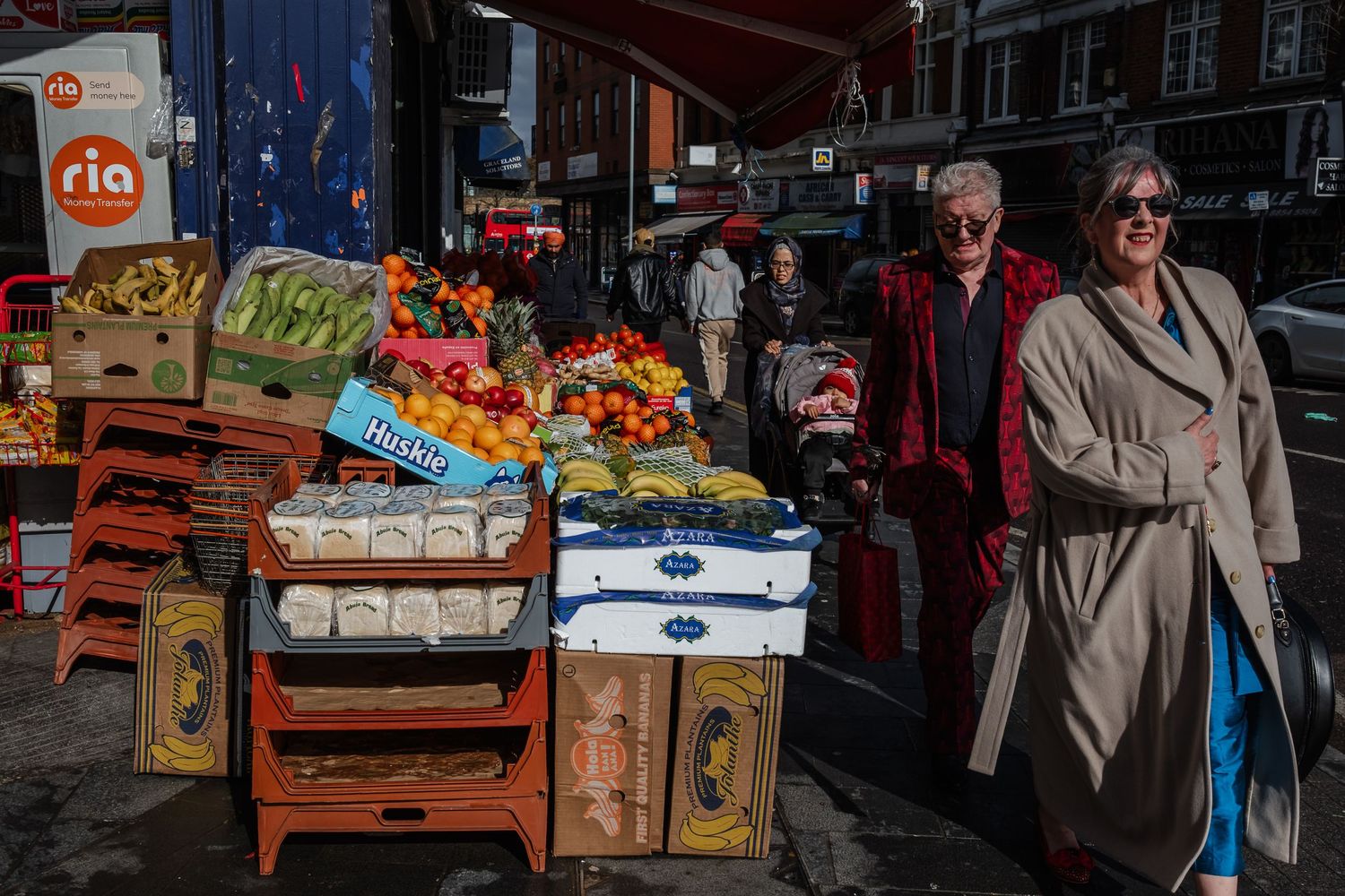Colorful produce market stall with wooden crates of fruits and vegetables on display.