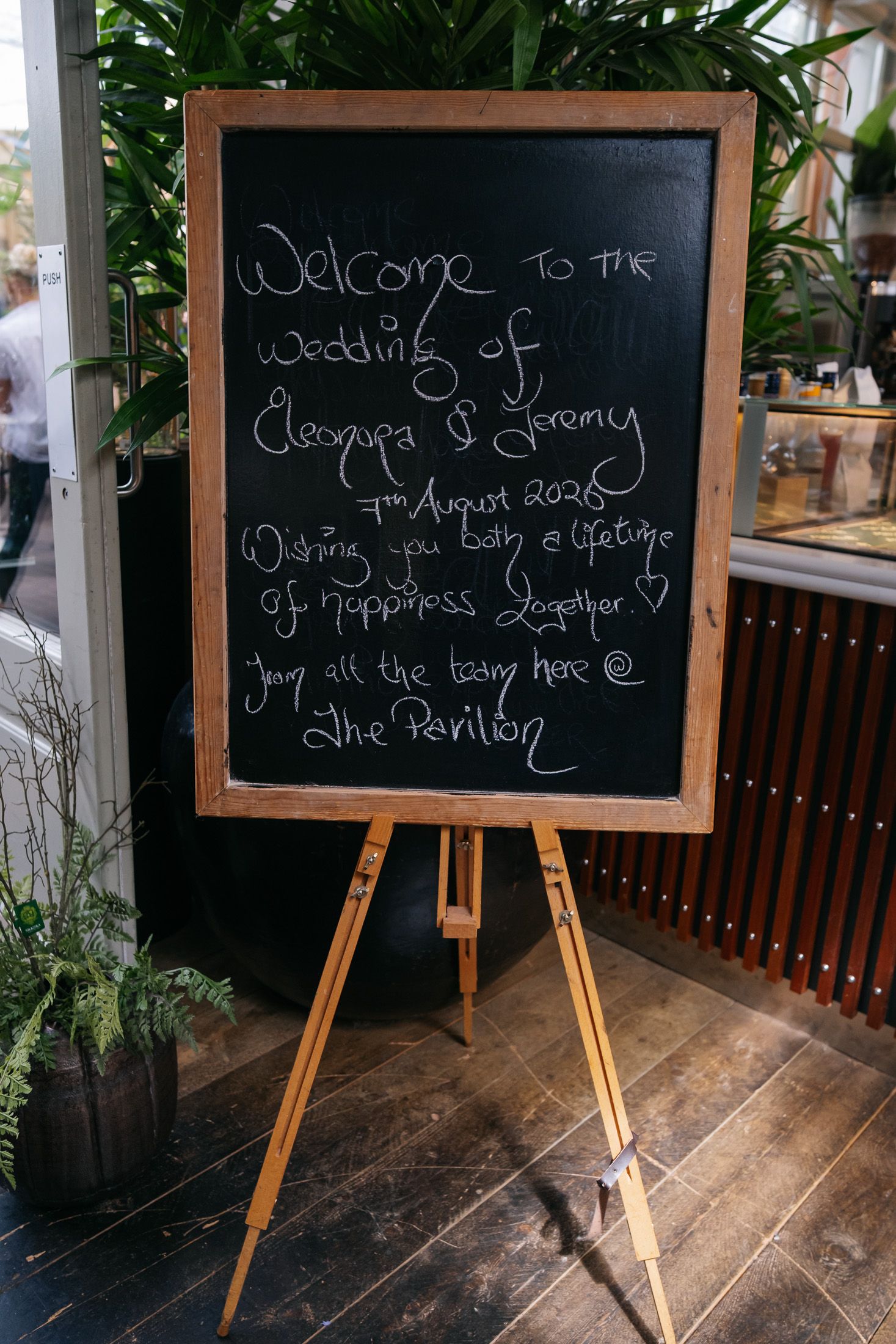 Chalkboard wedding welcome sign on easel for Cleopatra and Jeremy, August 7th 2026, at The Pavilion.