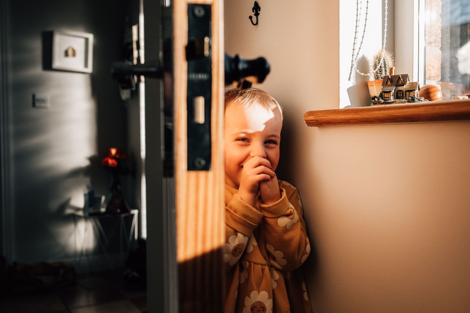 A curious peek around the corner in a cozy home setting.