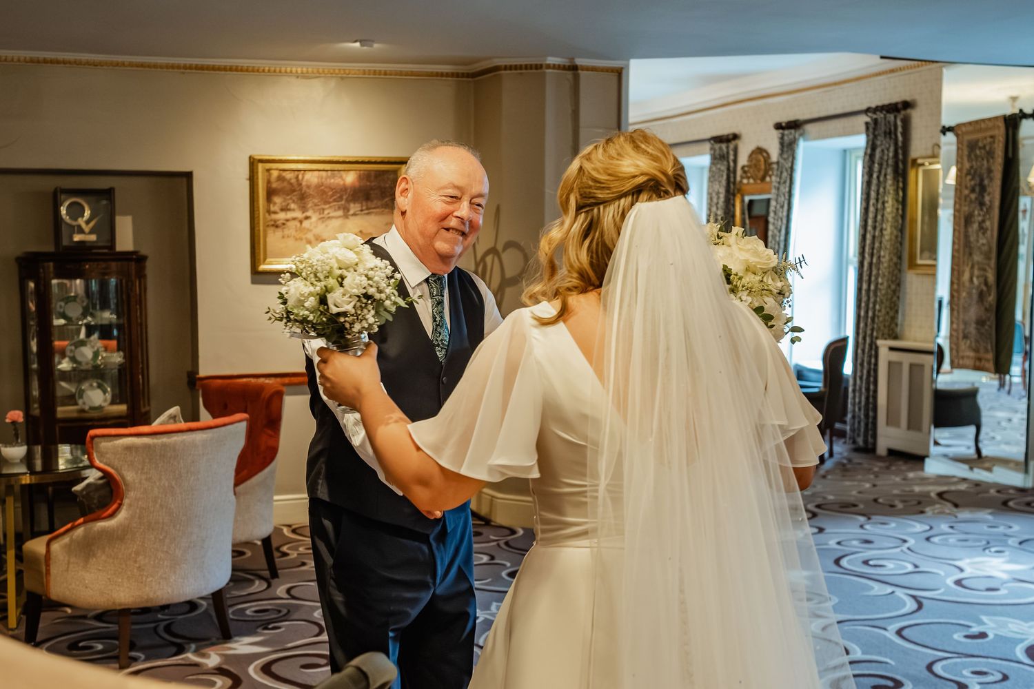 Emotional moment during wedding preparation in an elegant hotel room.