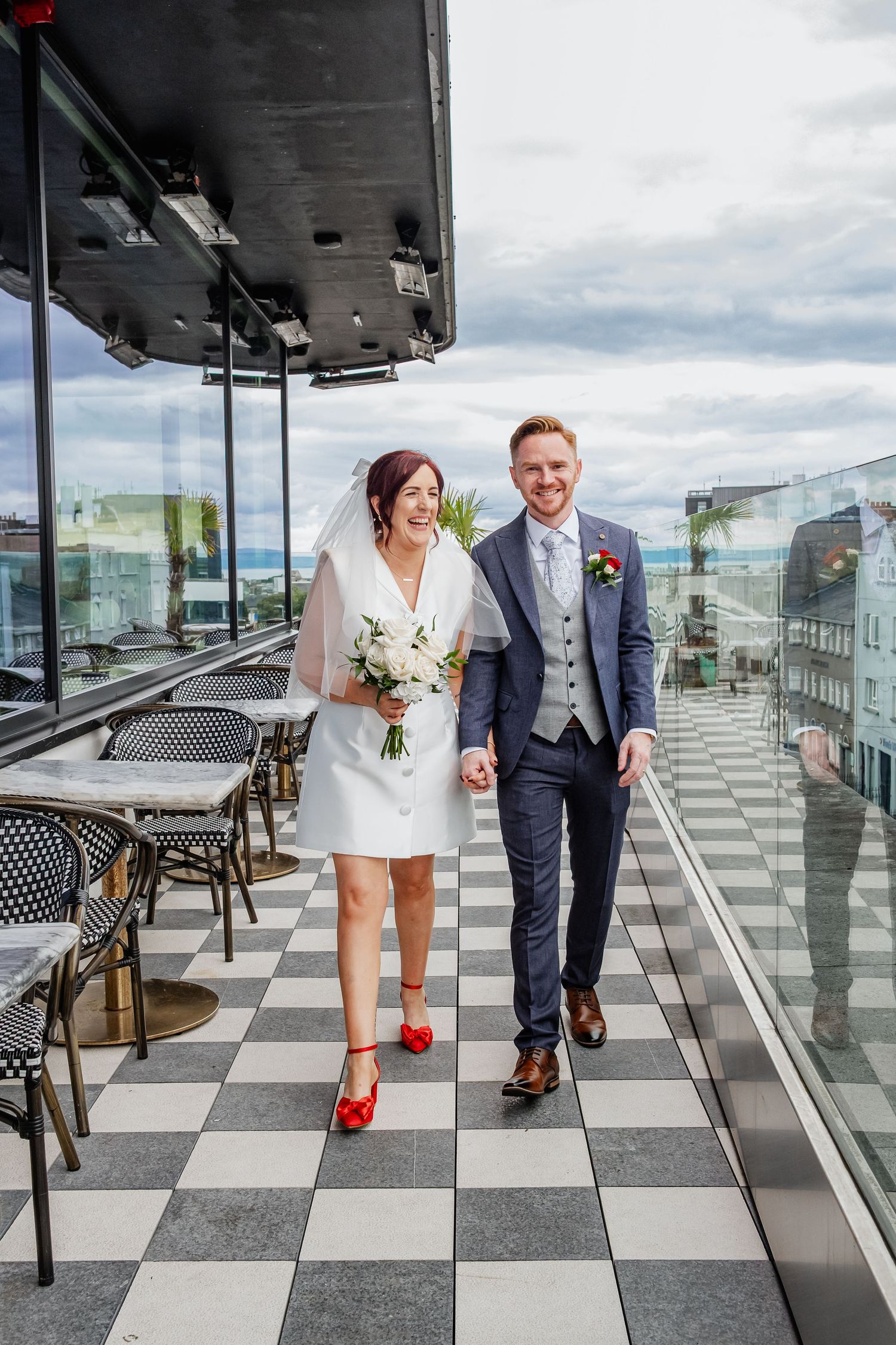 Creative wedding photo sequence showing couple on black and white checkered outdoor terrace with city views.