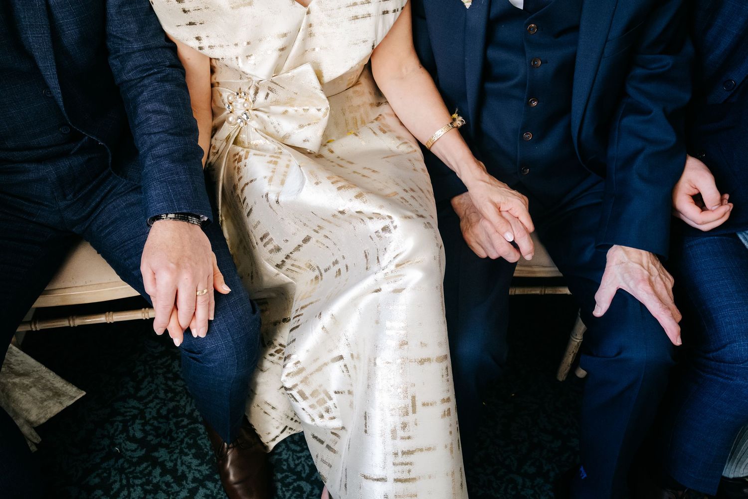 Close-up shot of a couple sitting together showing their formal wedding attire.