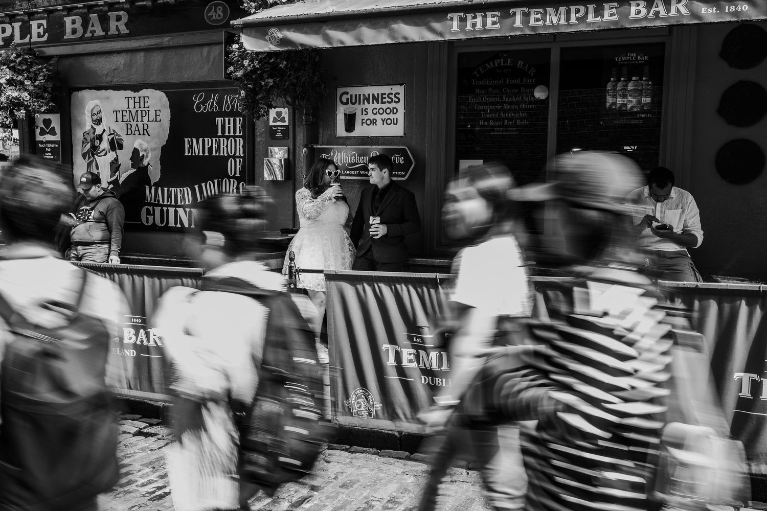 A motion blur black and white street scene outside The Temple Bar in Dublin.
