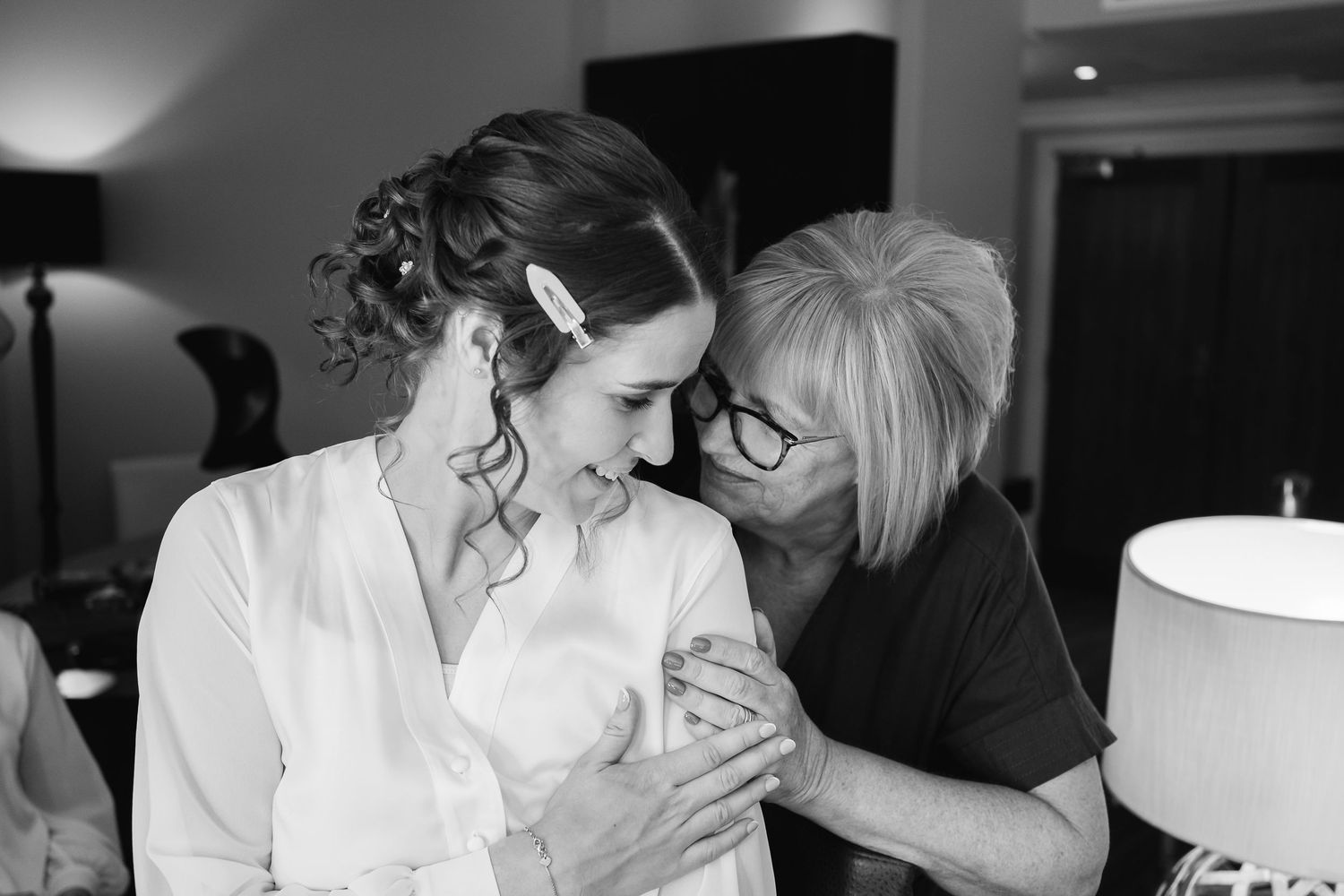 Black and white photos capturing intimate moments during wedding morning preparations.