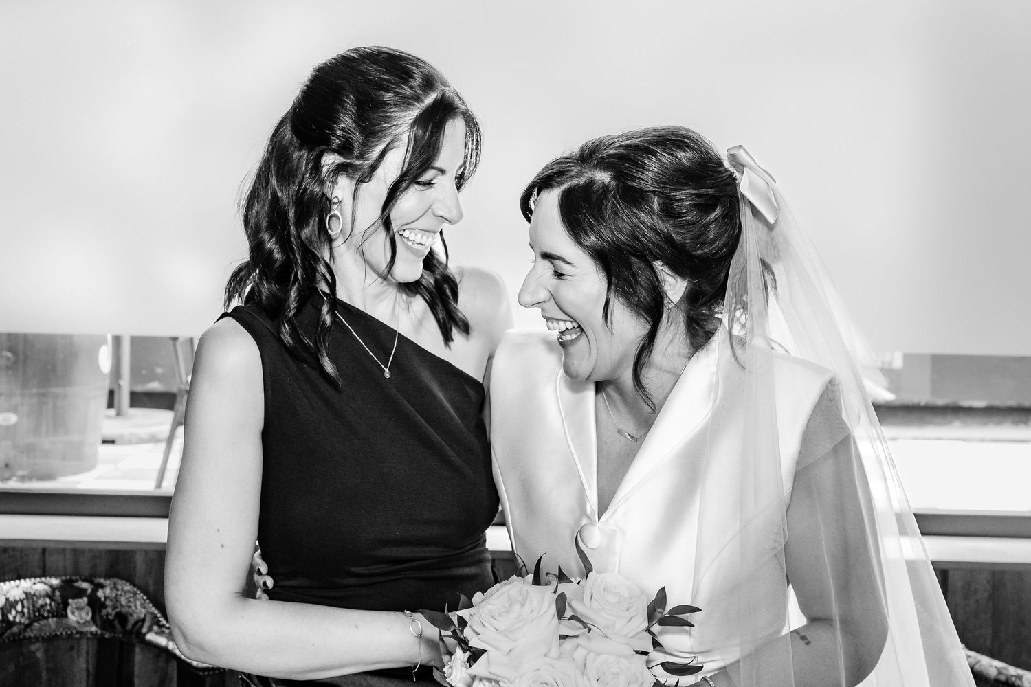 Black and white candid photo capturing emotional wedding day preparation moments.
