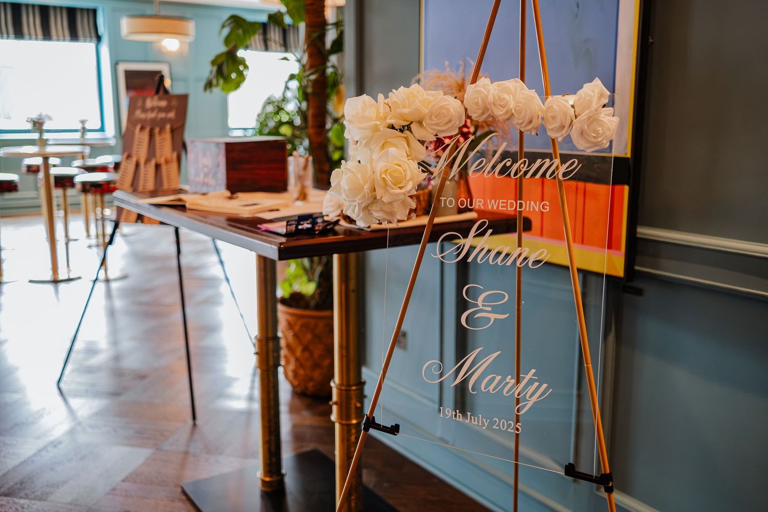Elegant floral wedding decorations and candles arranged on tables in a vintage-styled reception venue.