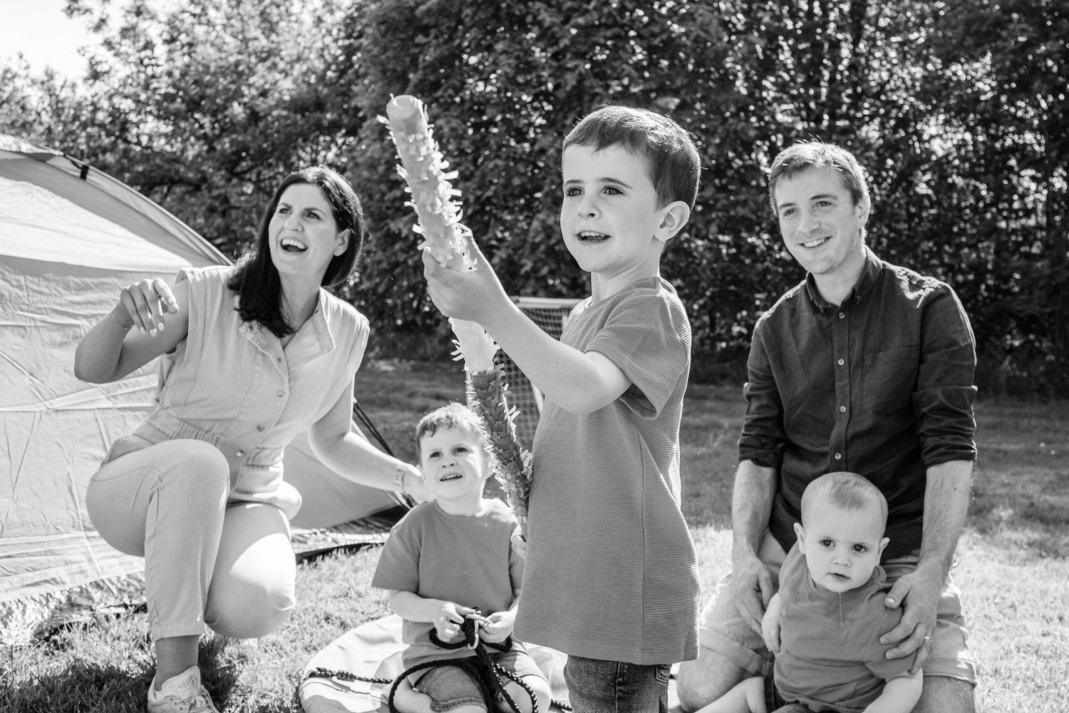 Group enjoying outdoor playtime in a backyard on a sunny day.