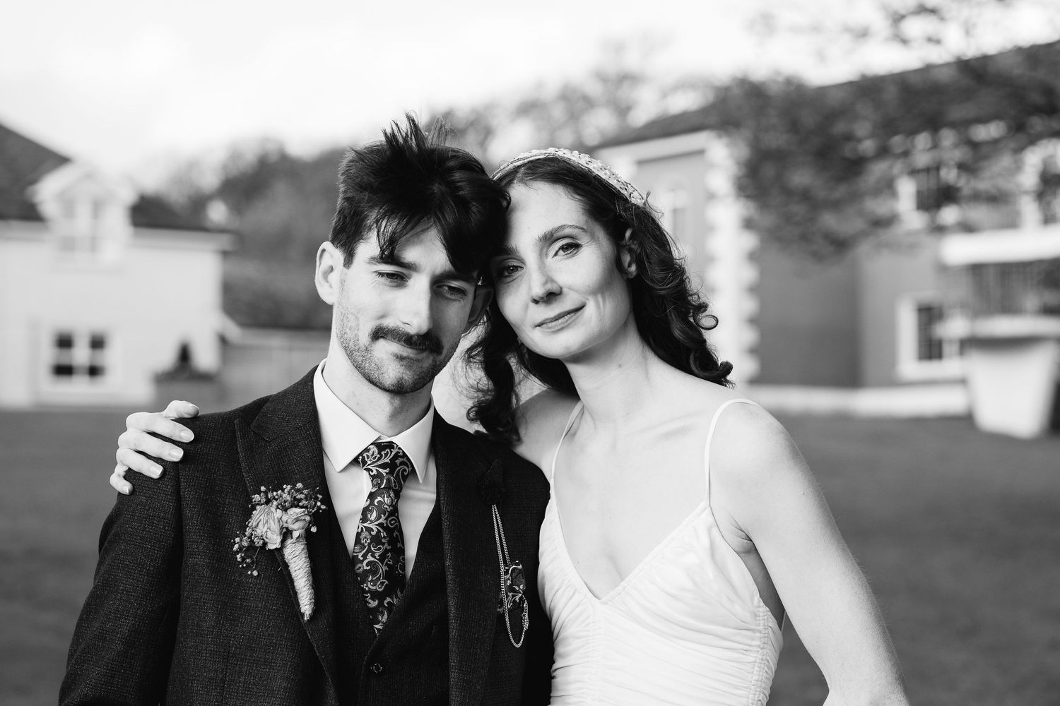 Black and white wedding photography captures intimate moments during an outdoor celebration.