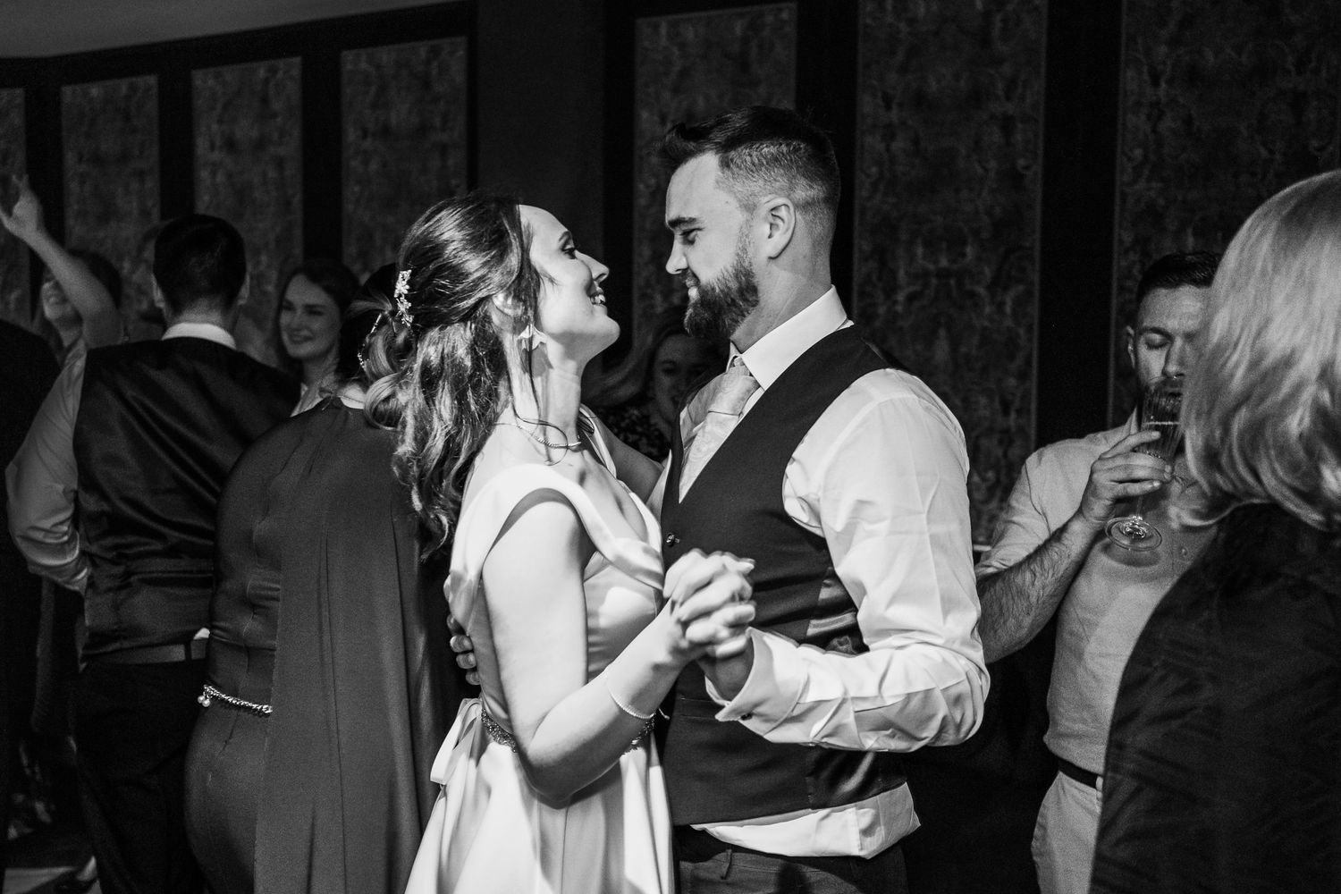 A couple sharing a romantic dance moment at an elegant evening celebration.