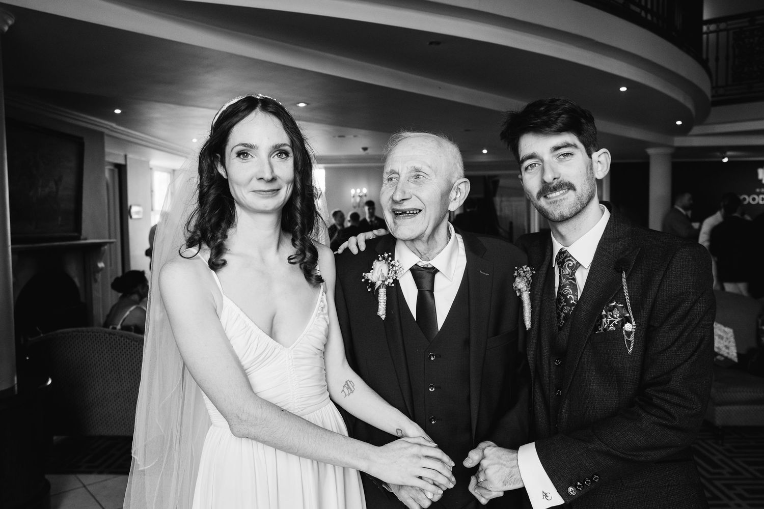 A black and white panoramic collage of candid moments from a formal evening event.