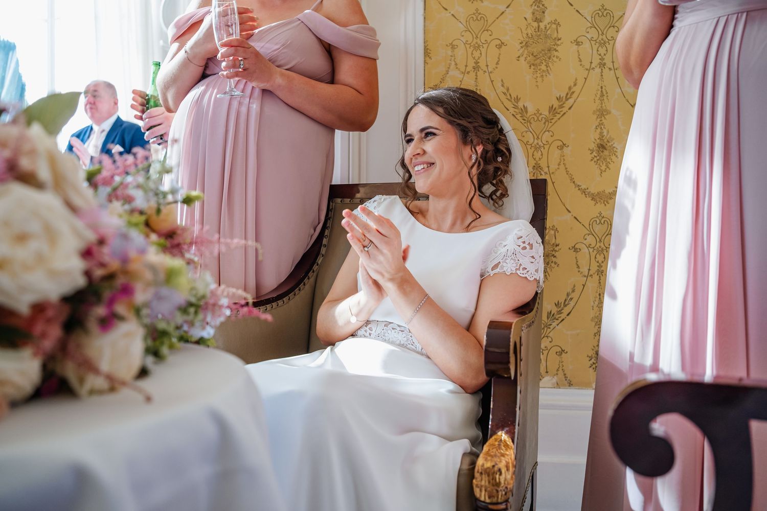 An elegant room decorated in soft pink and gold tones sets the scene for a formal celebration.