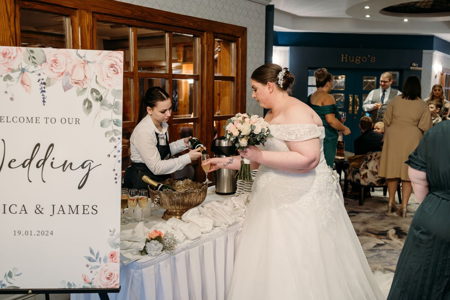 The wedding reception features a welcome sign and decorated refreshment table.