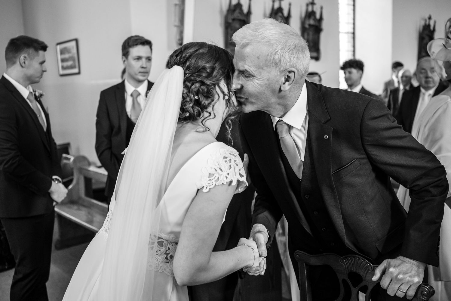 Collection of candid black and white photos showing wedding ceremony moments in church or chapel setting.