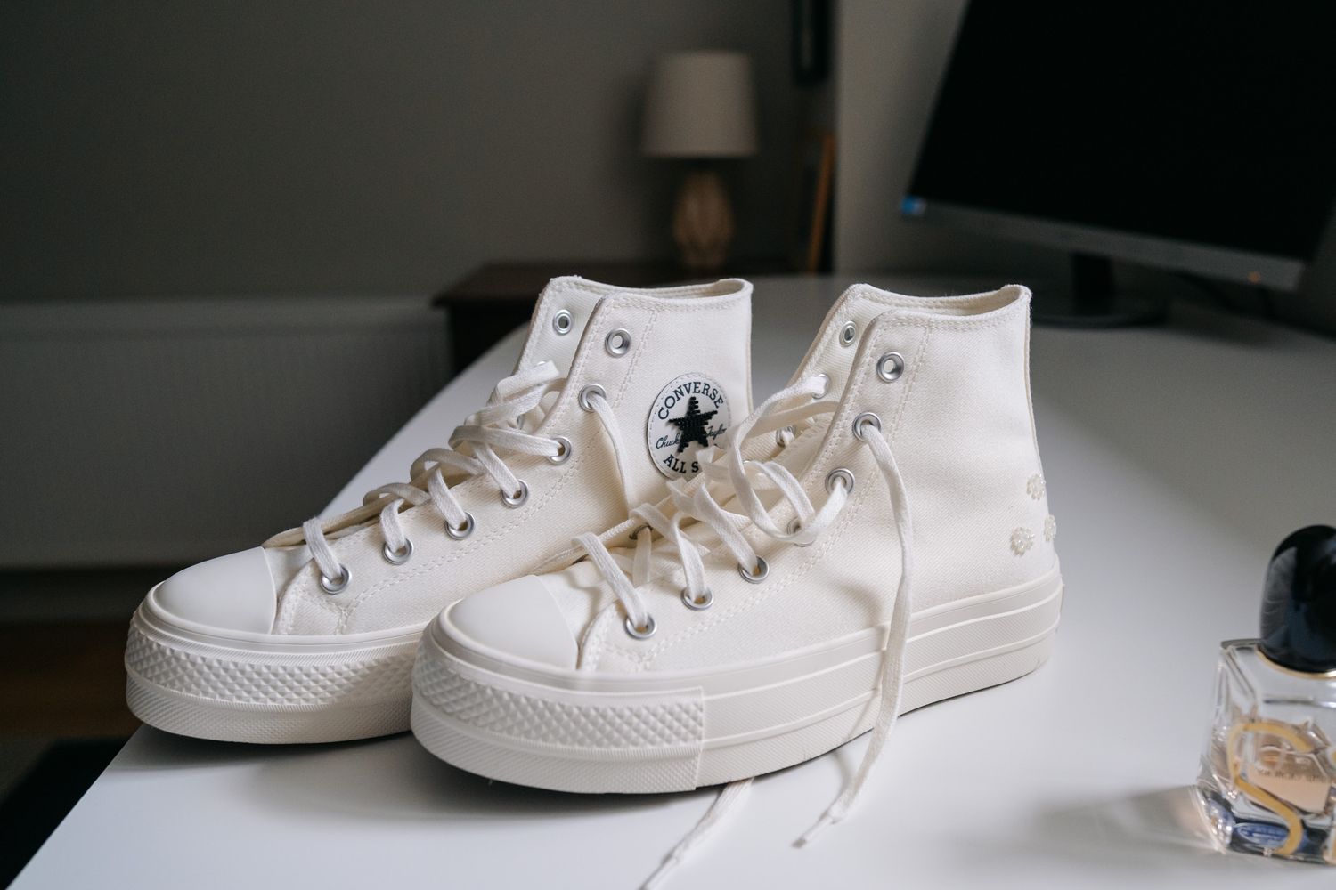 White Converse Chuck Taylor All Star high-top sneakers with platform sole displayed on a white surface.