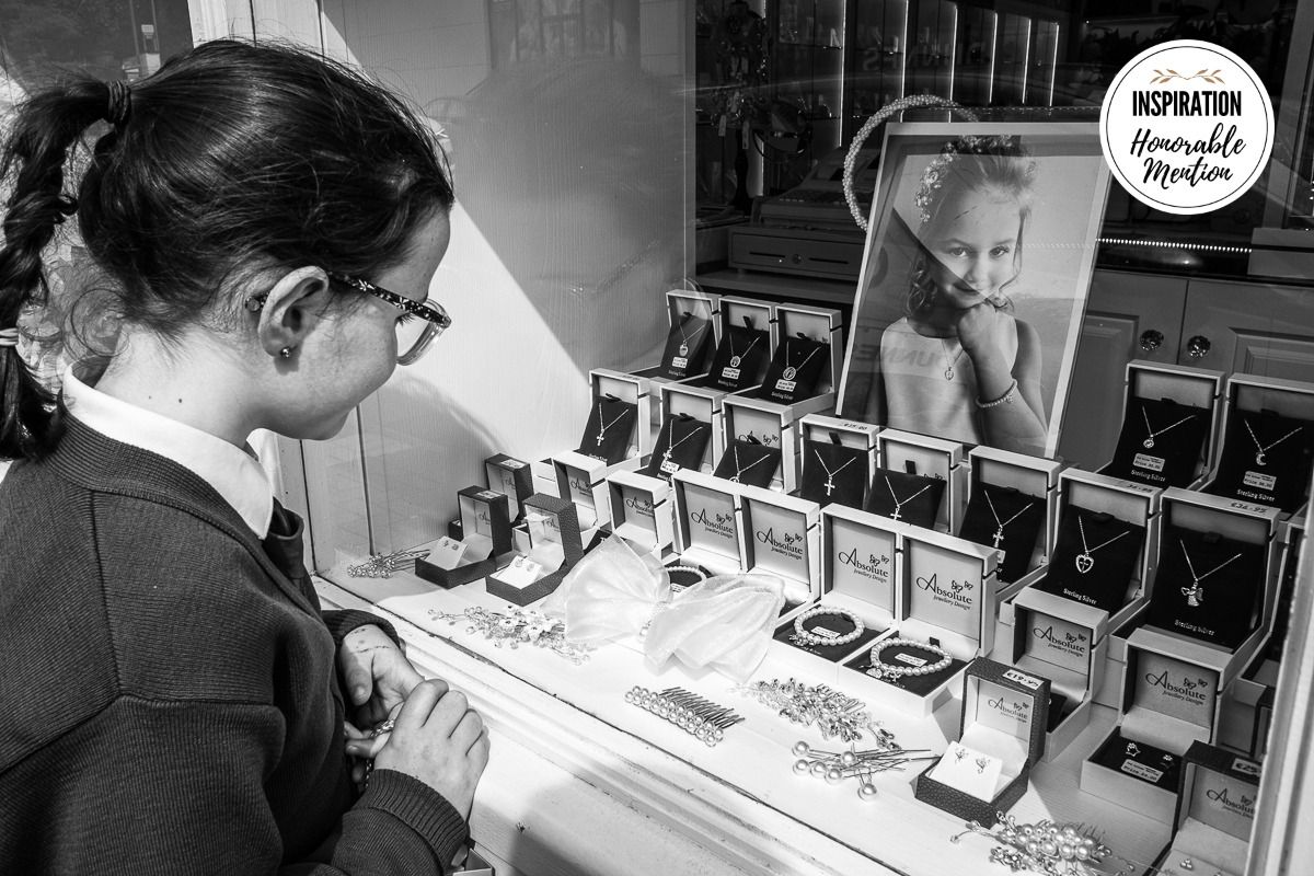 A series of black and white photographs showing someone signing books at a table during an author event.