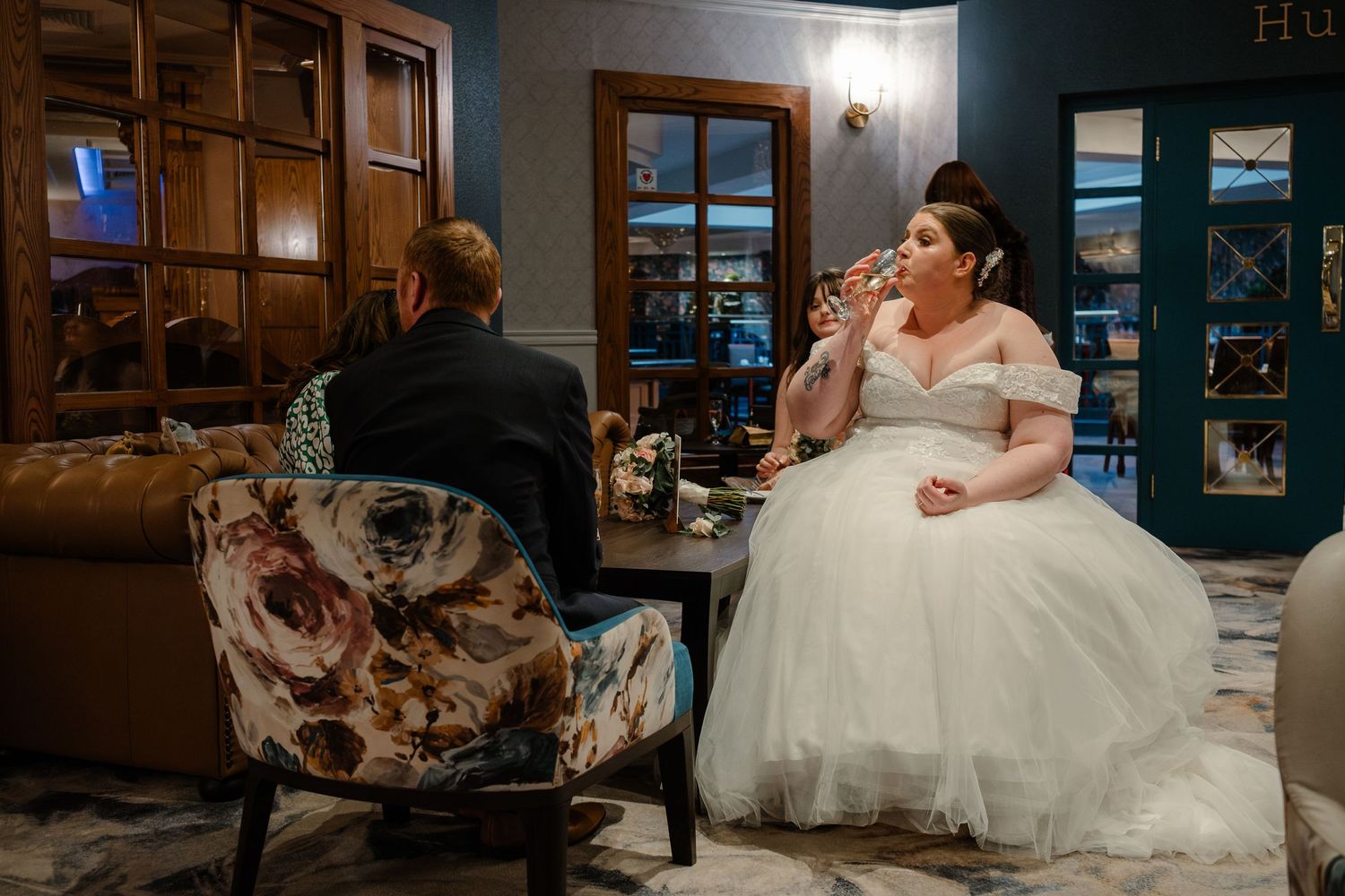 A quiet moment during the wedding reception in an elegantly furnished room.