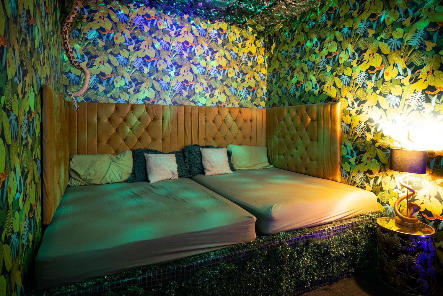 Adult play area with floral wallpaper and cushioned seating at Penthouse Playrooms Dunstable, creating a warm and inviting atmosphere