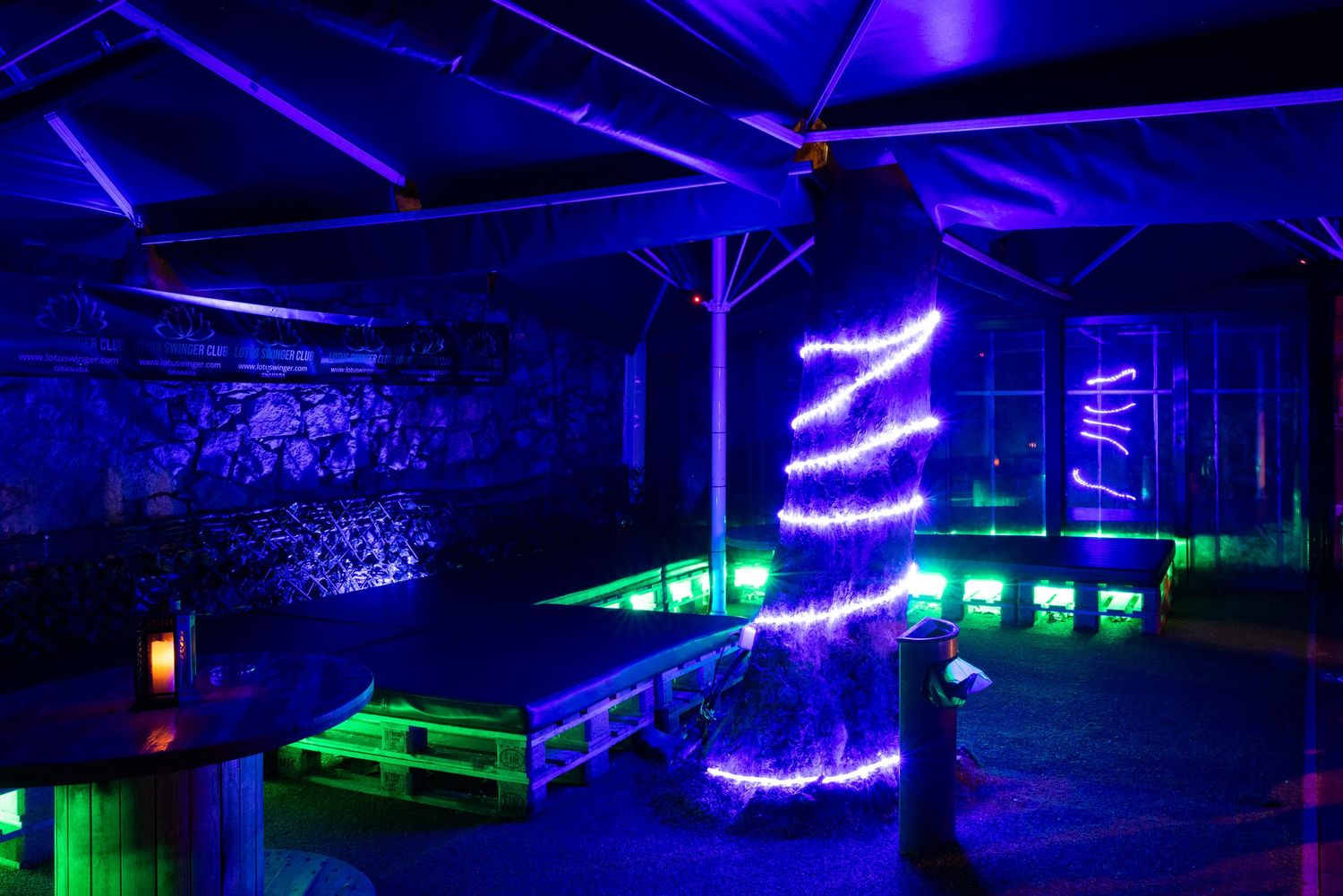 Blue and green neon lighting in industrial space at Club Oops Barcelona, creating a futuristic nightclub interior atmosphere