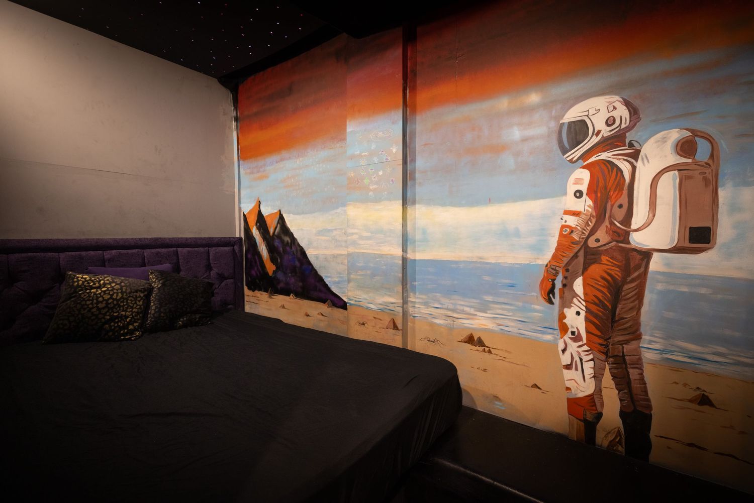 Bedroom set with themed décor at Penthouse Playrooms Dunstable, featuring immersive design and ambient lighting