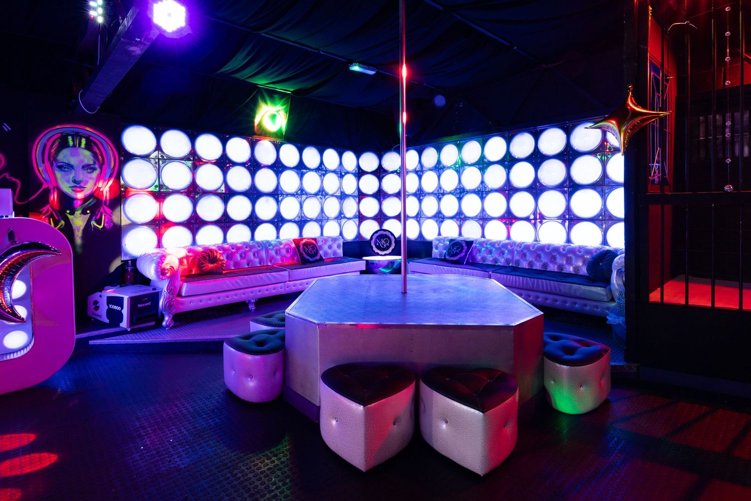 LED-lit nightclub interior with purple and blue lighting at Penthouse Playrooms Dunstable, creating a vibrant atmospheric ambience