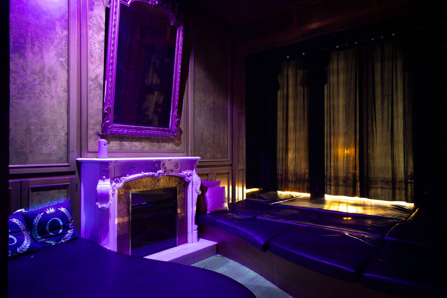 Purple and blue lit hallway with wooden panels at Club Oops Barcelona, creating a moody, atmospheric nightclub interior