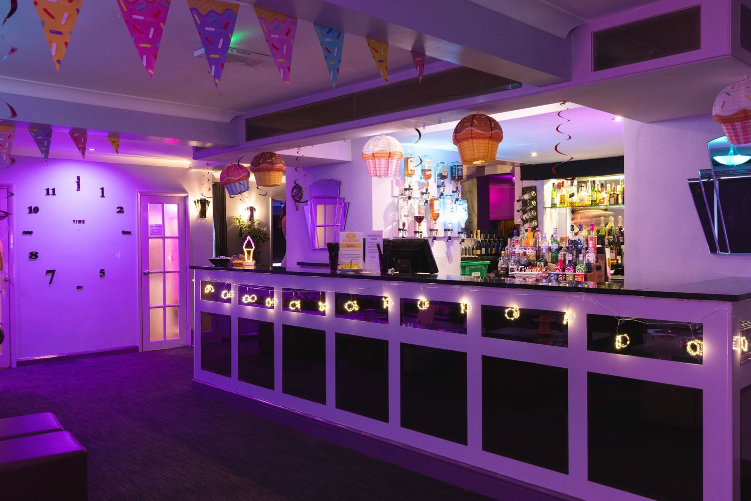 Modern nightclub interior with purple LED lighting at Liberty Elite Lutterworth, illuminating bar area, adult club interior photography